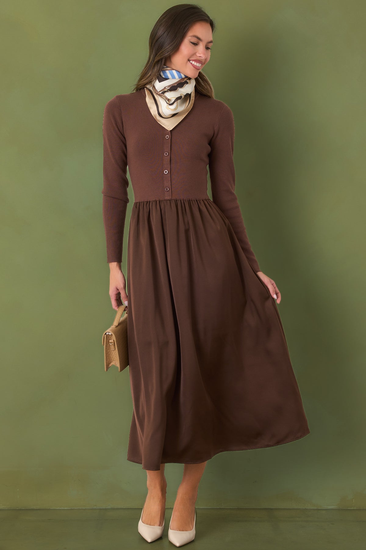 Knit and satin midi dress featuring a round neckline, tonal buttons, defined waist, and gently flared skirt.