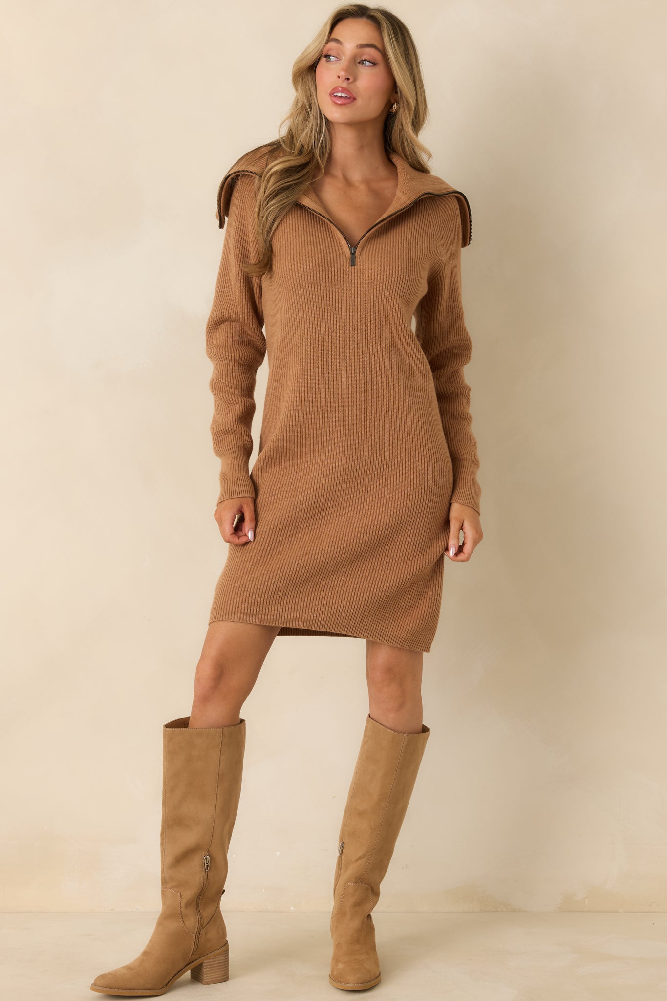 Knit camel dress featuring vertical ribbing and cozy longline silhouette.