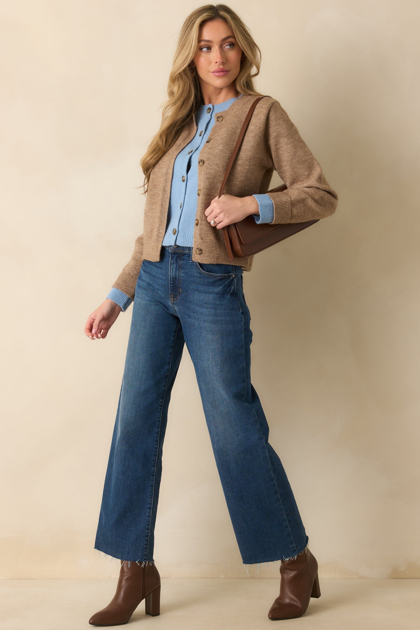 Knit cardigan with ribbed crew neckline, functional buttons, and subtle faux layering for a stylish two-tone effect.