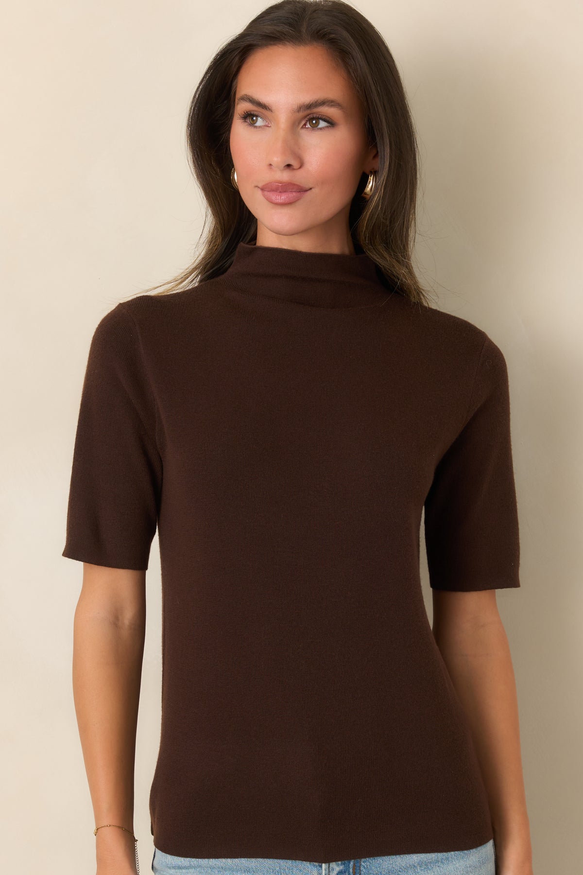 Knit top featuring a clean turtleneck and neatly finished short sleeves.
