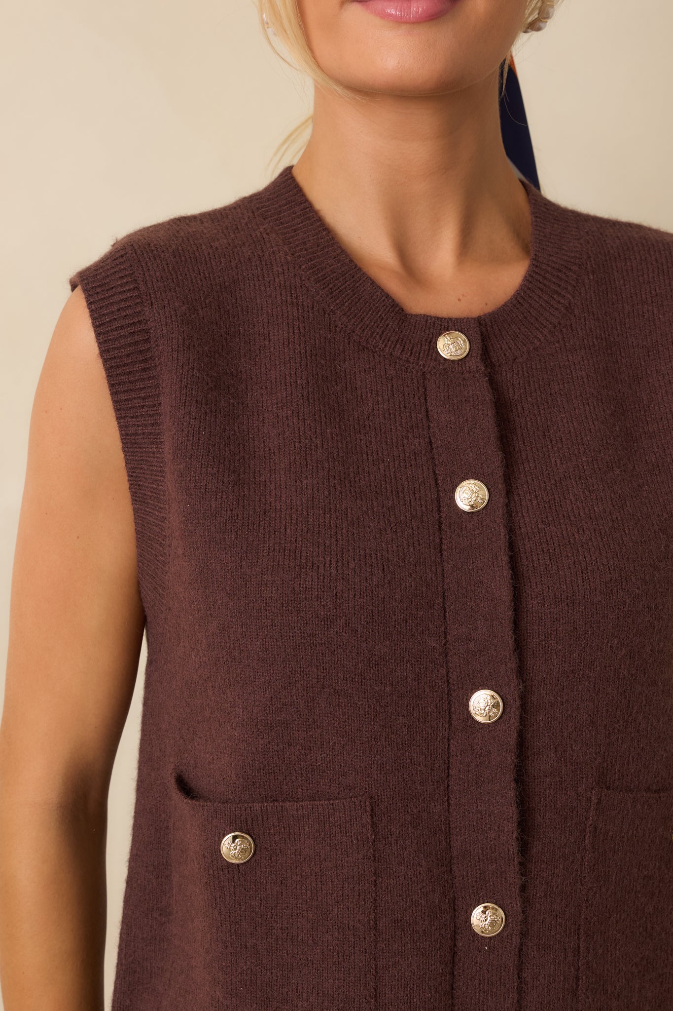 Detailed shot of the knit fabric, front buttons, and patch pocket construction.