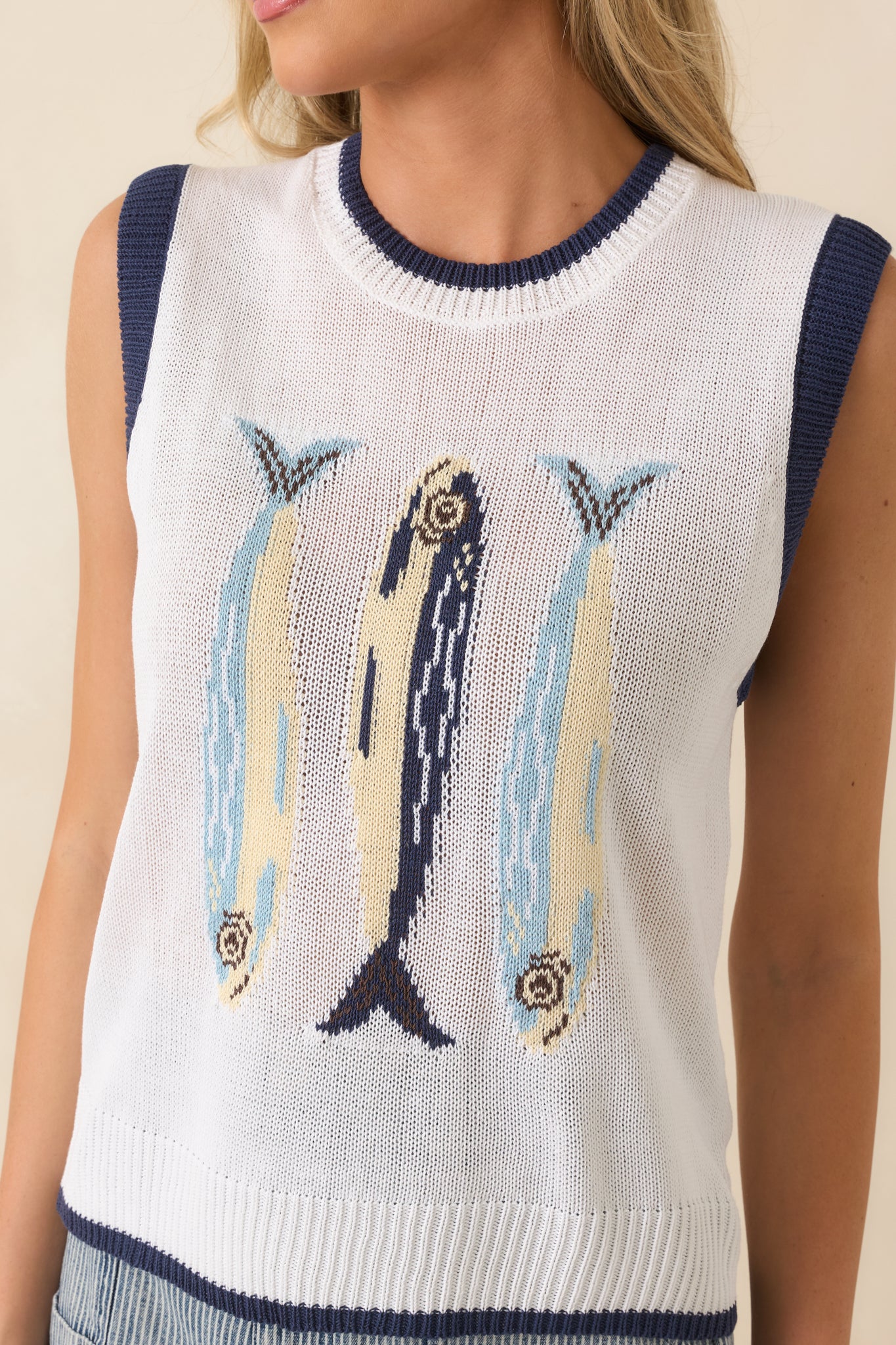 Detailed look at the knit fish appliqués, lightweight sweater texture, and contrast navy trim.