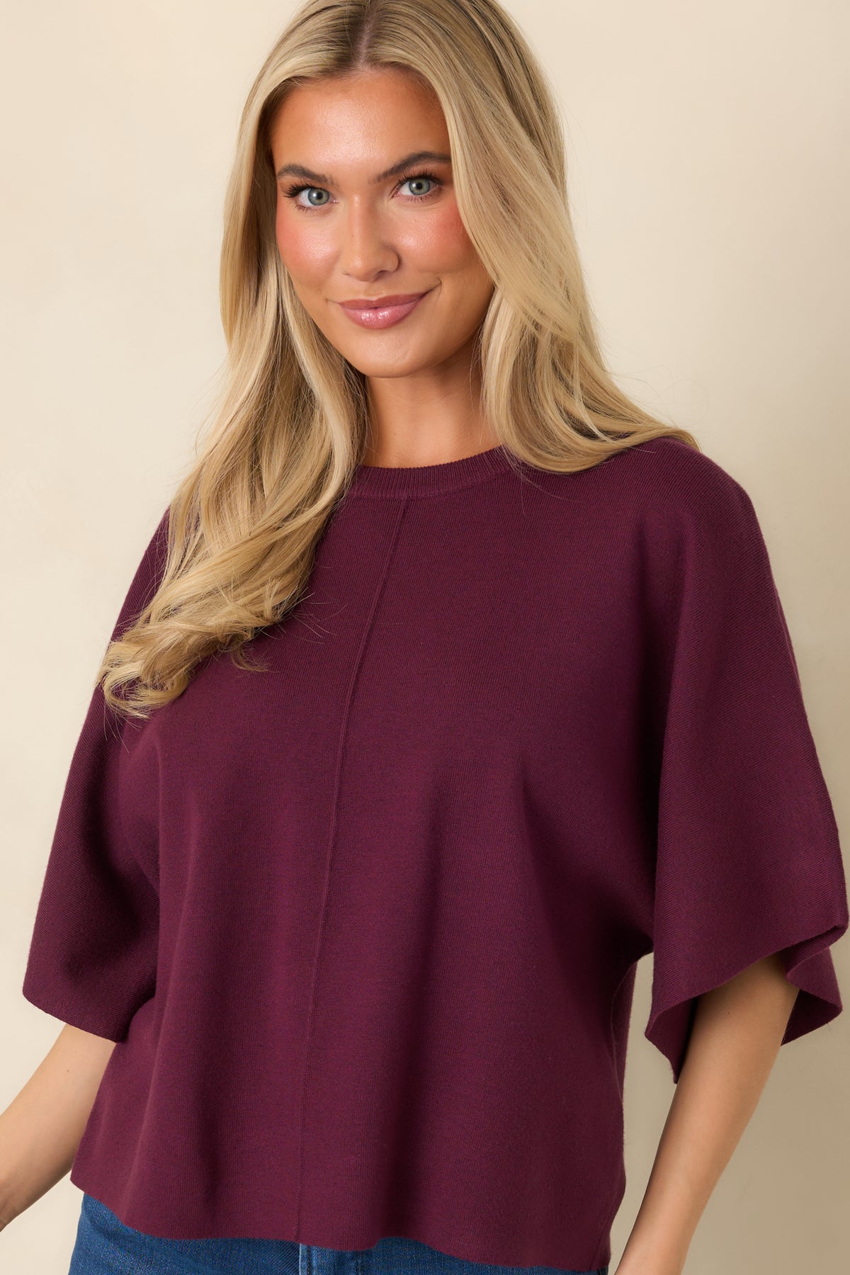 Wide round neckline finished with subtle ribbed trim on the relaxed knit pullover.