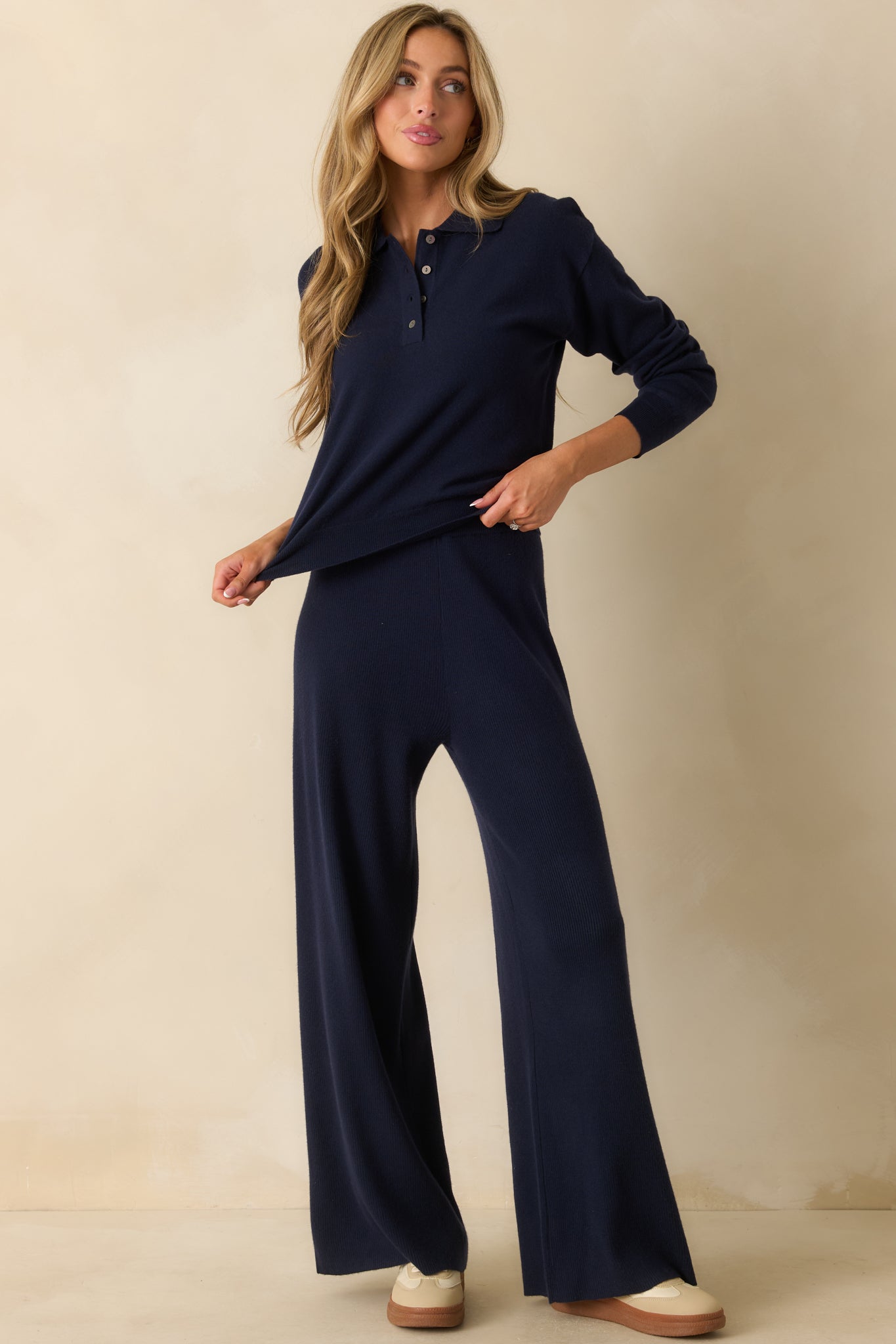 Knit top emphasizing the partial button placket and smooth drape of the fabric.