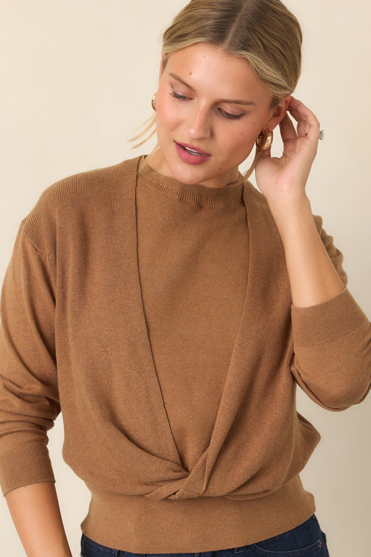 Knit top showcasing the sleeveless base beneath the coordinating twisted long-sleeve layer.
