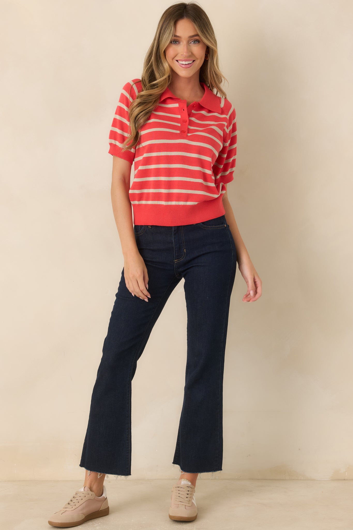 Knit top featuring coral red and beige stripes, a coordinating polo collar, and a functional button placket.