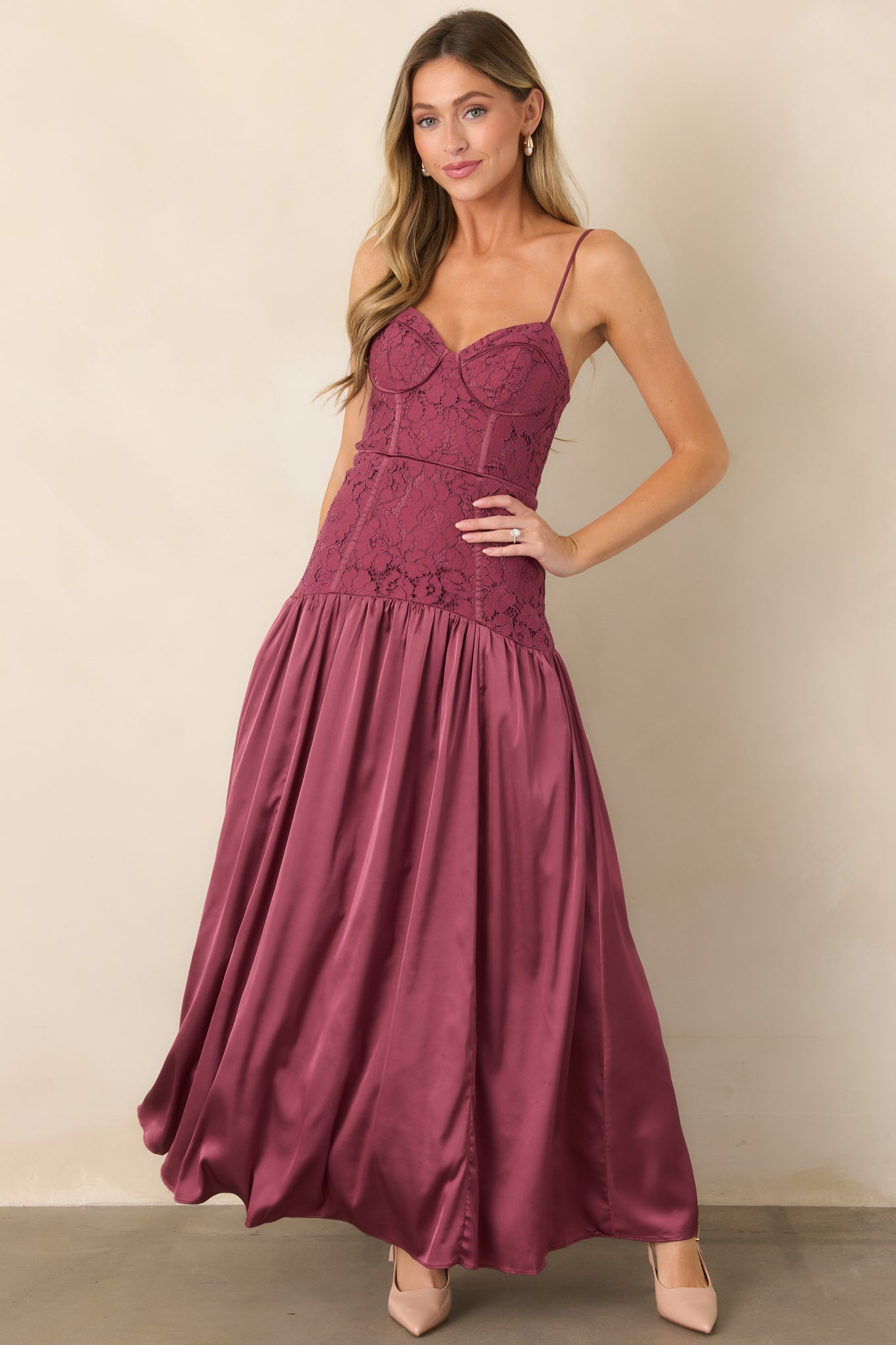 Satin and lace dress featuring a fitted bustier top, delicate adjustable shoulder straps, dropped waistline, and softly gathered full-length skirt.