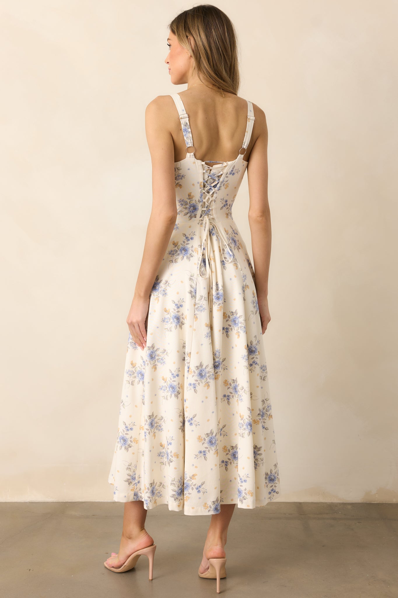 The lace-up corset back of this periwinkle dress adds a touch of romance, perfectly complementing the flowing silhouette.