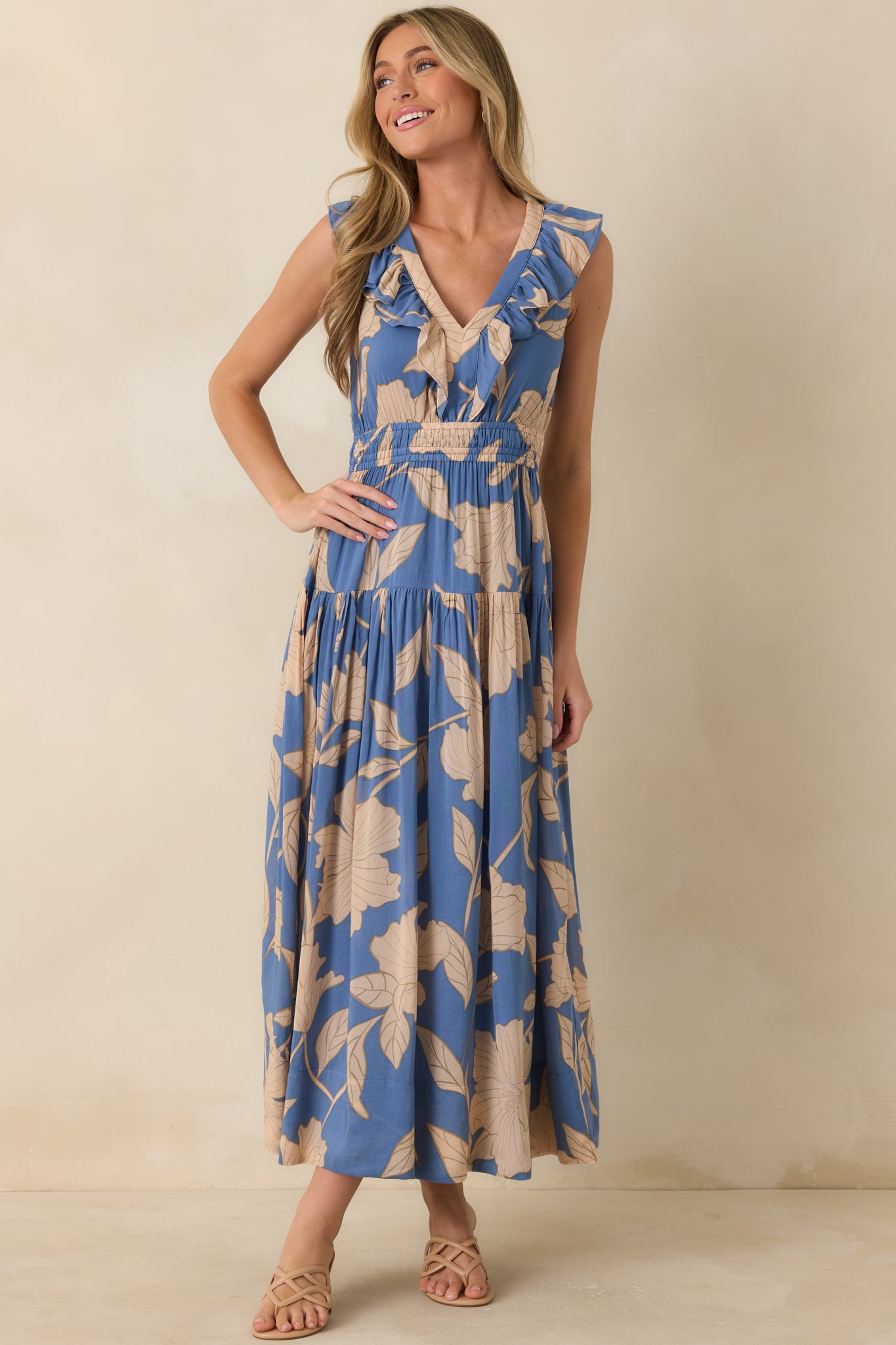 Lake blue floral maxi dress featuring a relaxed flowy fit, oversized floral print, sleeveless silhouette, and softly gathered tiered skirt.
