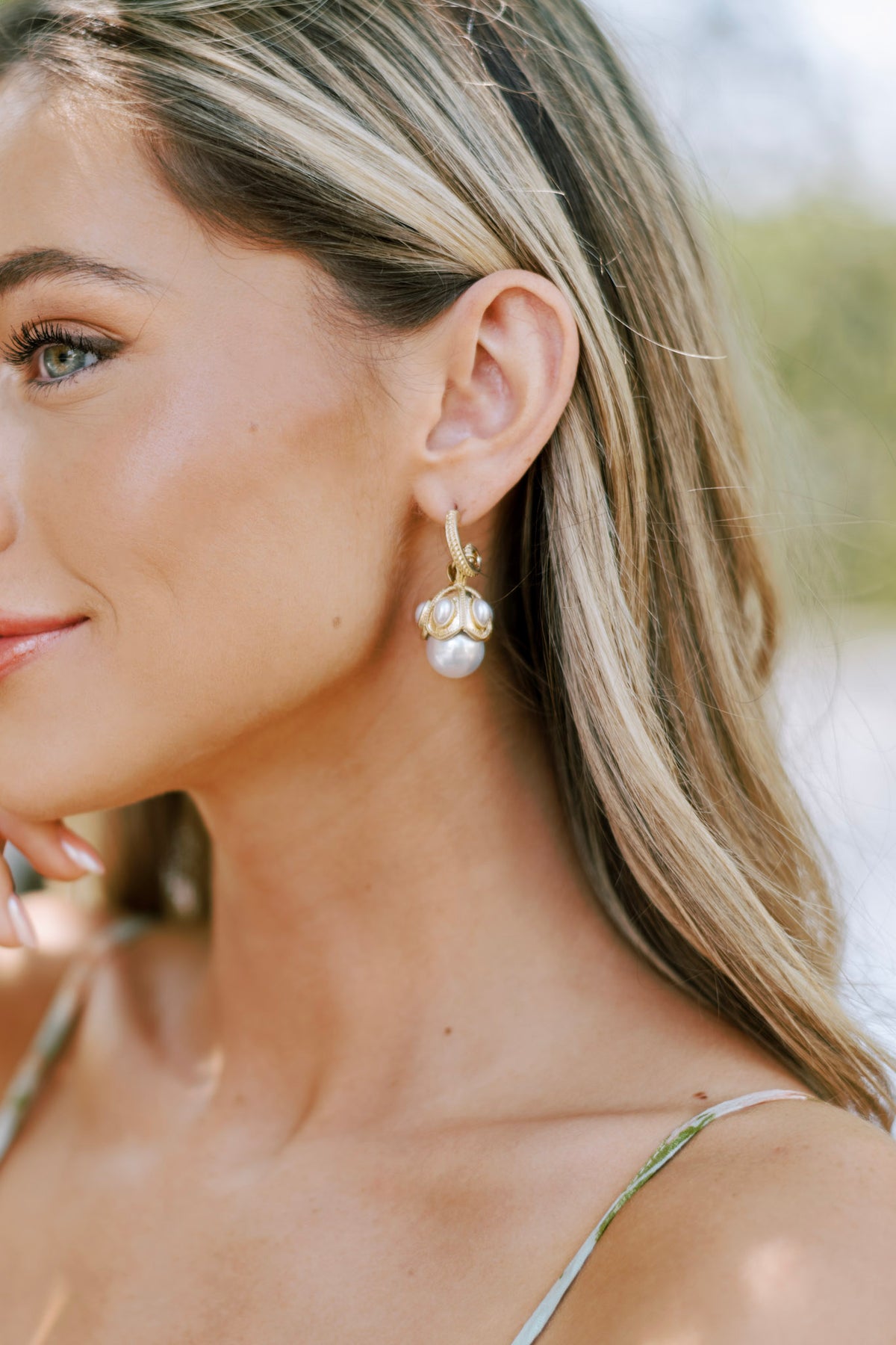 Large faux pearls paired with sculpted gold accents and smaller pearls on these decorative earrings.