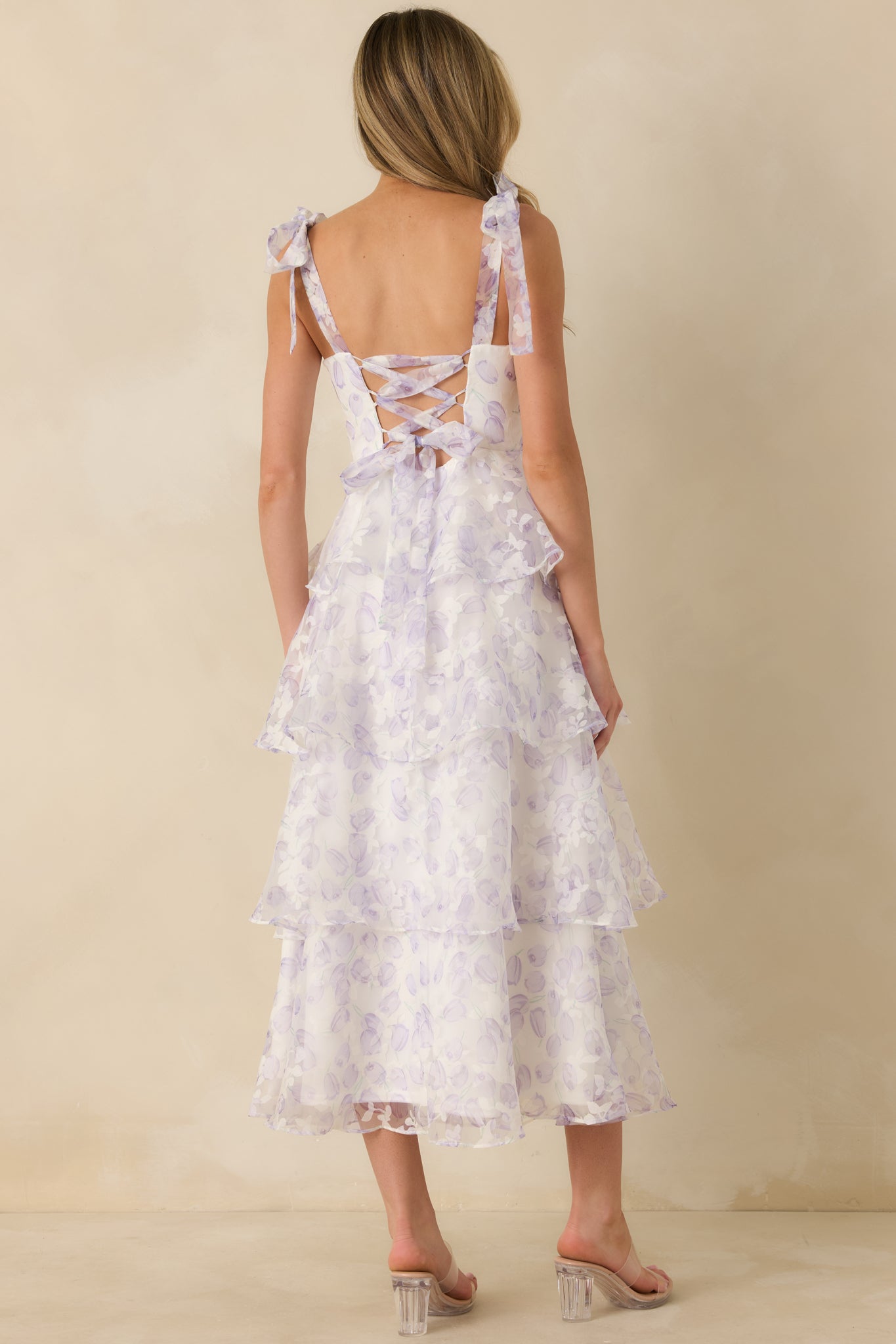 Back view of the lavender midi dress showing the adjustable lace-up corset back and hidden zipper closure.