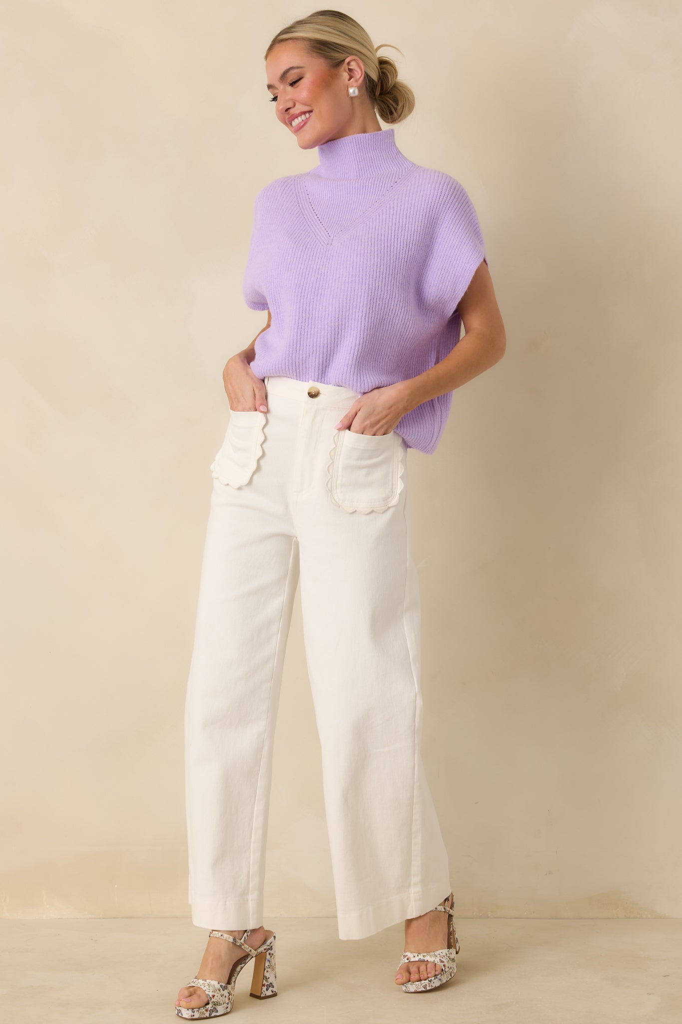 Lavender ribbed knit sweater with a mock neckline, cap sleeves, and relaxed fit.