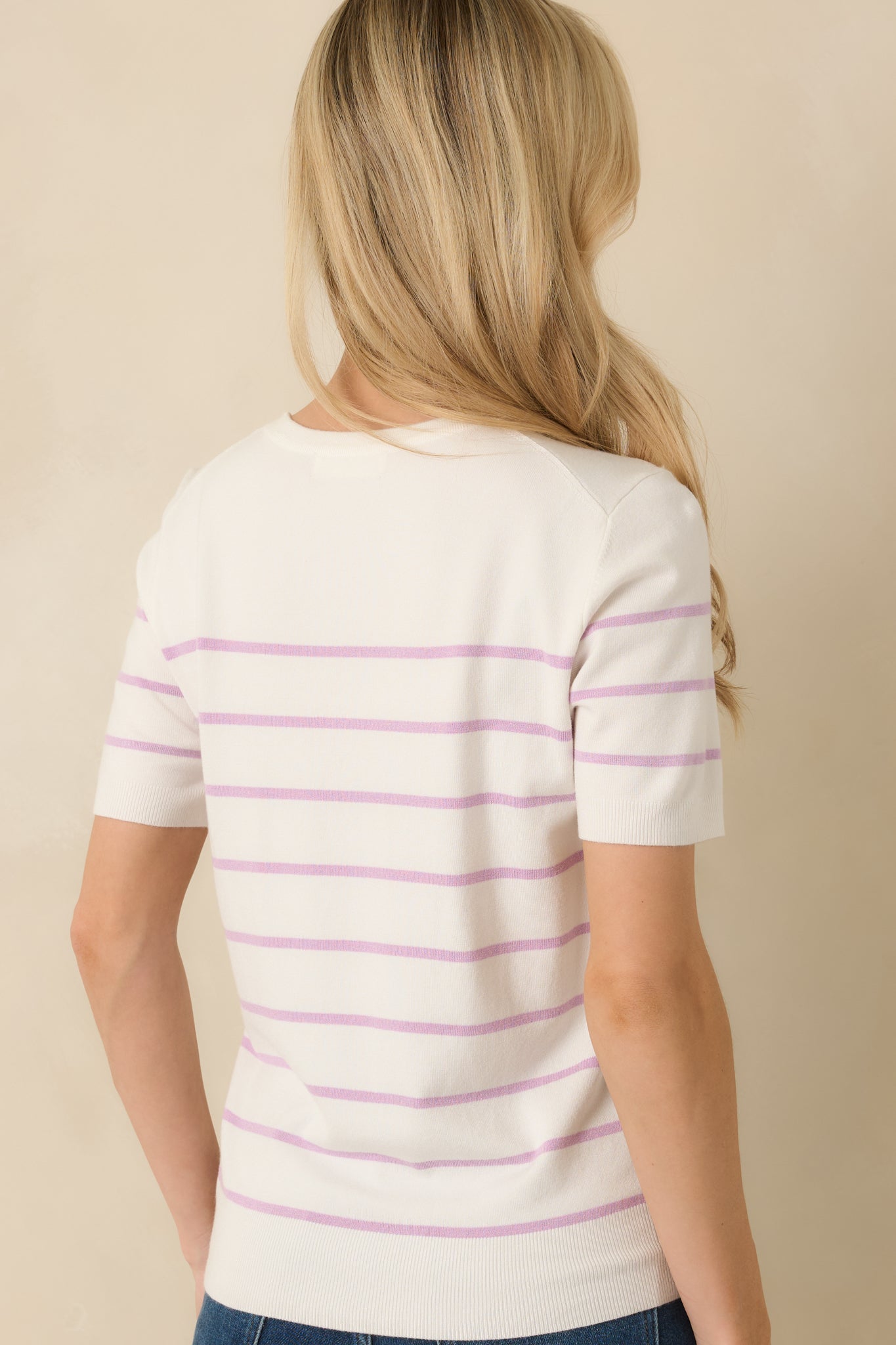 Lavender striped short-sleeve sweater with ribbed trim at neckline, sleeves, and hem for structured fit.