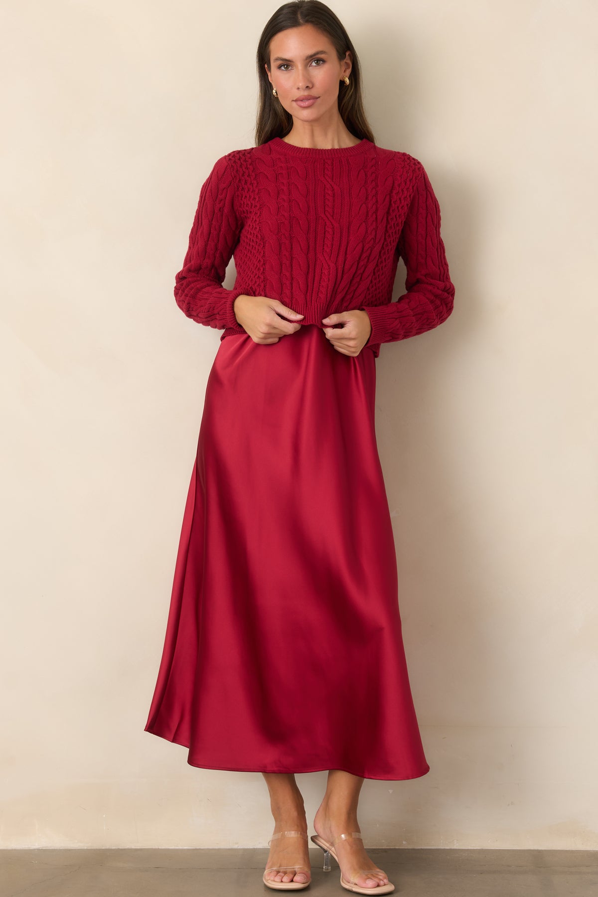 Layered maxi dress set combining a flowing satin skirt with an intricately textured cable-knit sweater.