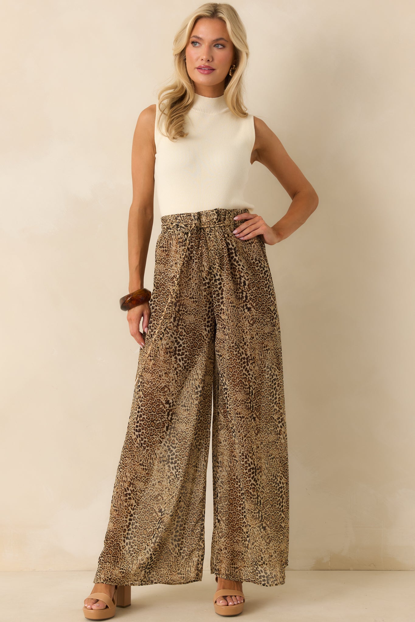Leopard print chiffon pants with wide legs and high rise waist styled with a self-tie belt.