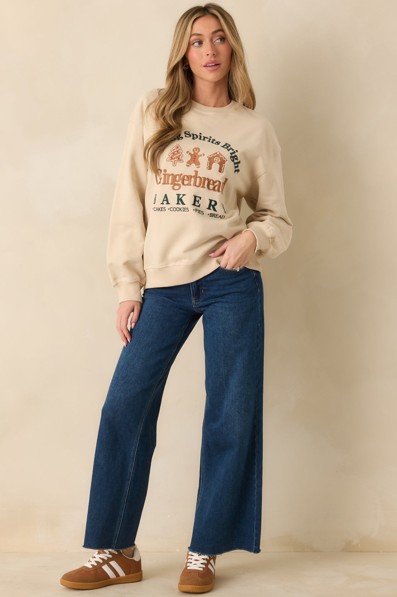 Light beige fleece sweatshirt showing the gingerbread bakery embroidery across the front.