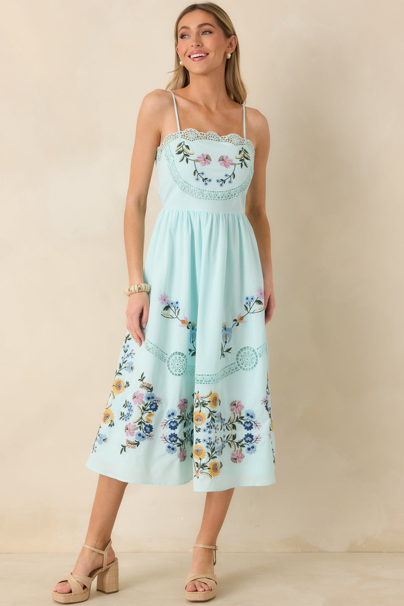 Floral embroidered light blue dress with open-ladder lace inserts and discreet side zipper.