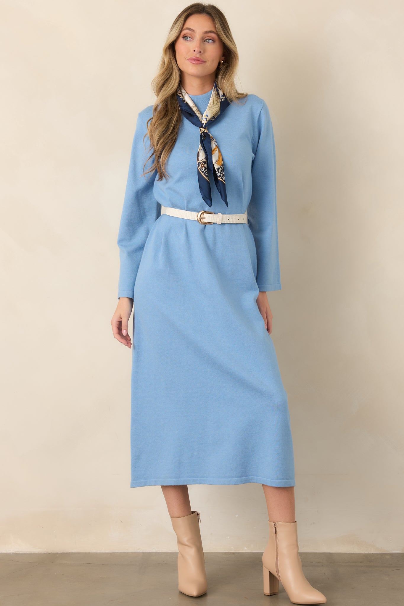 Light blue knit midi dress featuring a mock neckline, long sleeves, relaxed shift silhouette, and clean hem.