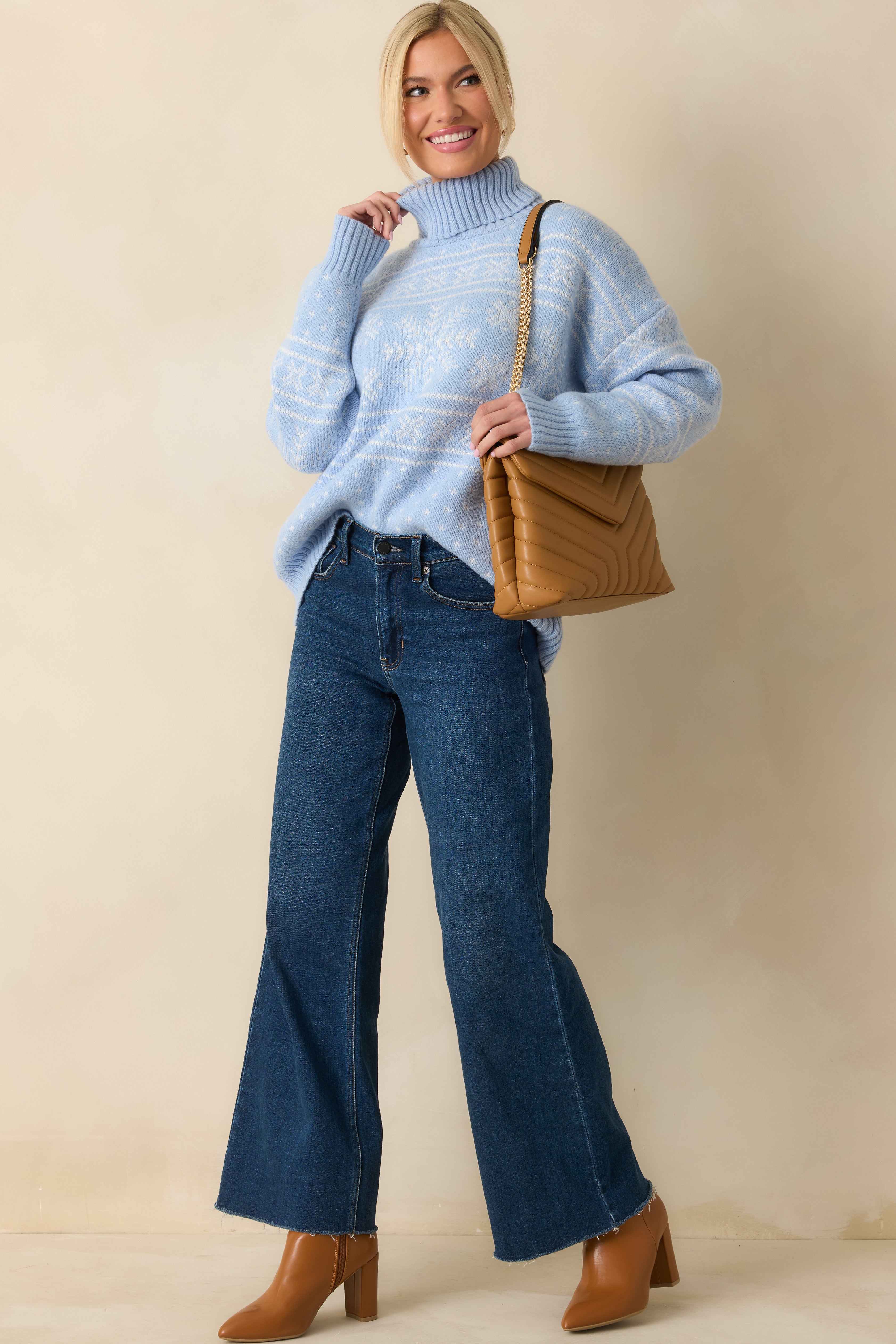 Knit sweater in light blue tones highlighting its fair-isle details and comfortable, laid-back silhouette.