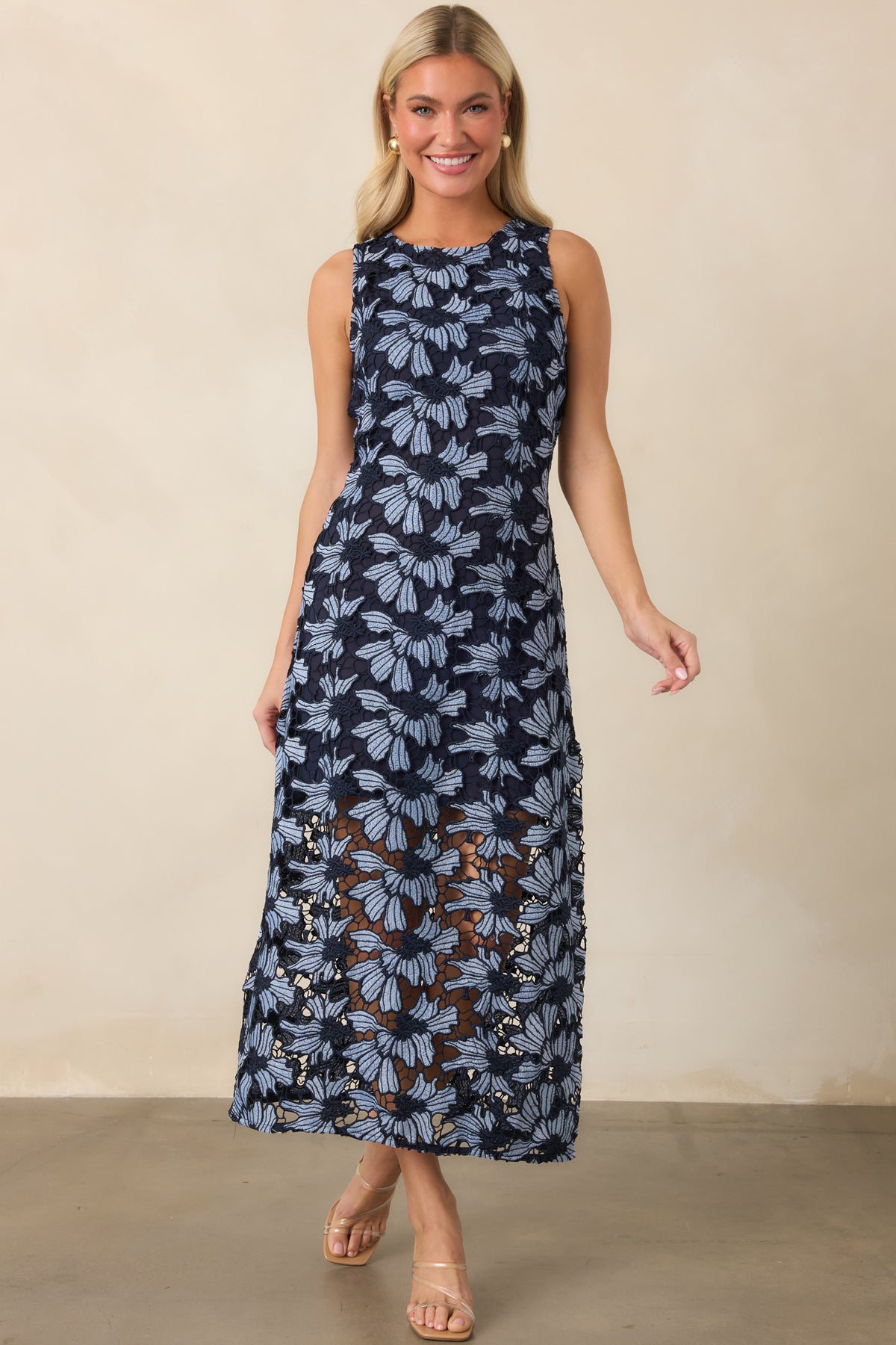 Light blue dress with a rounded neckline, sleeveless cut, and gently flared skirt revealing a delicate lace finish.