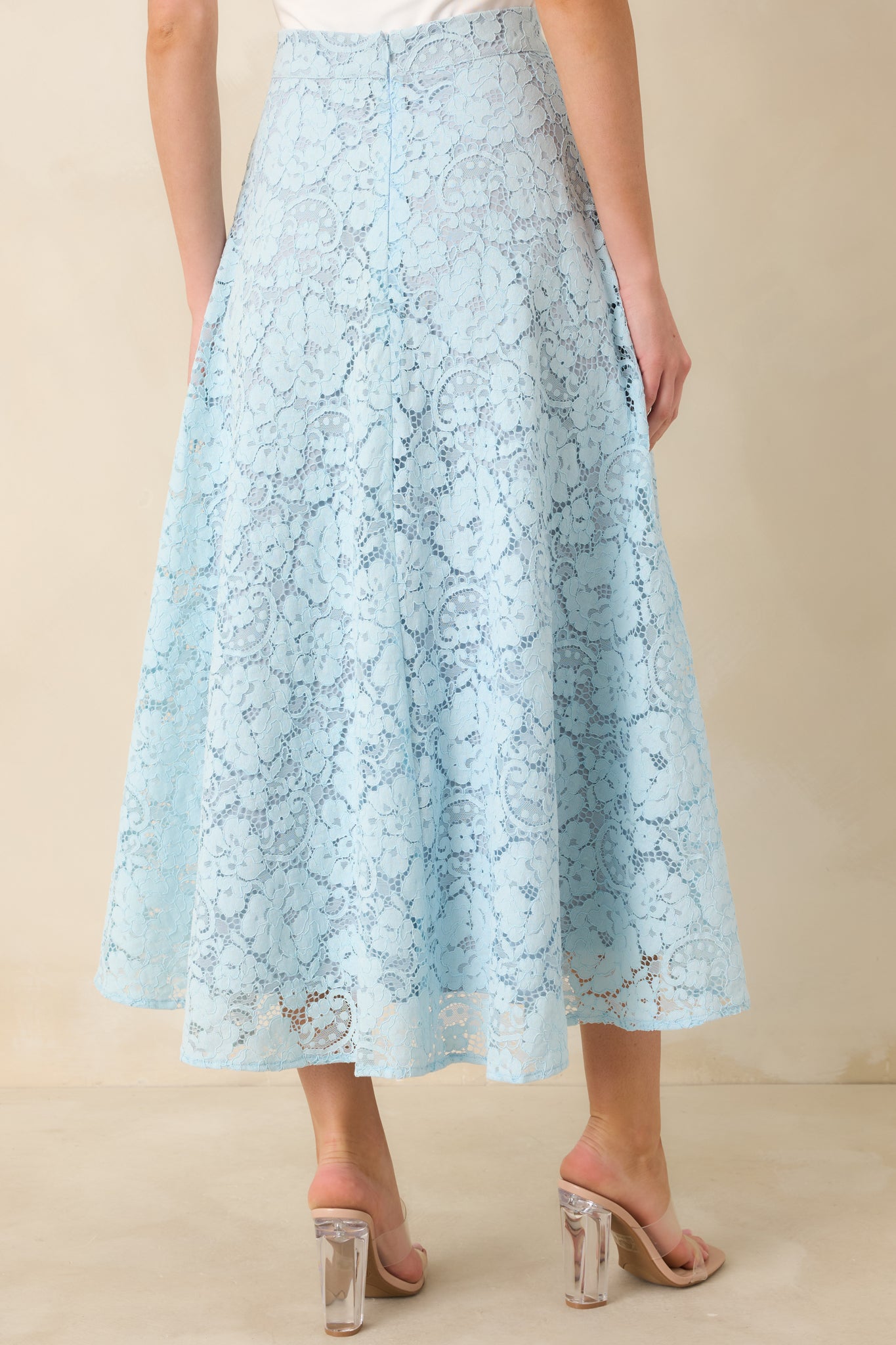 Light blue guipure skirt with discreet zipper closure and flared silhouette.