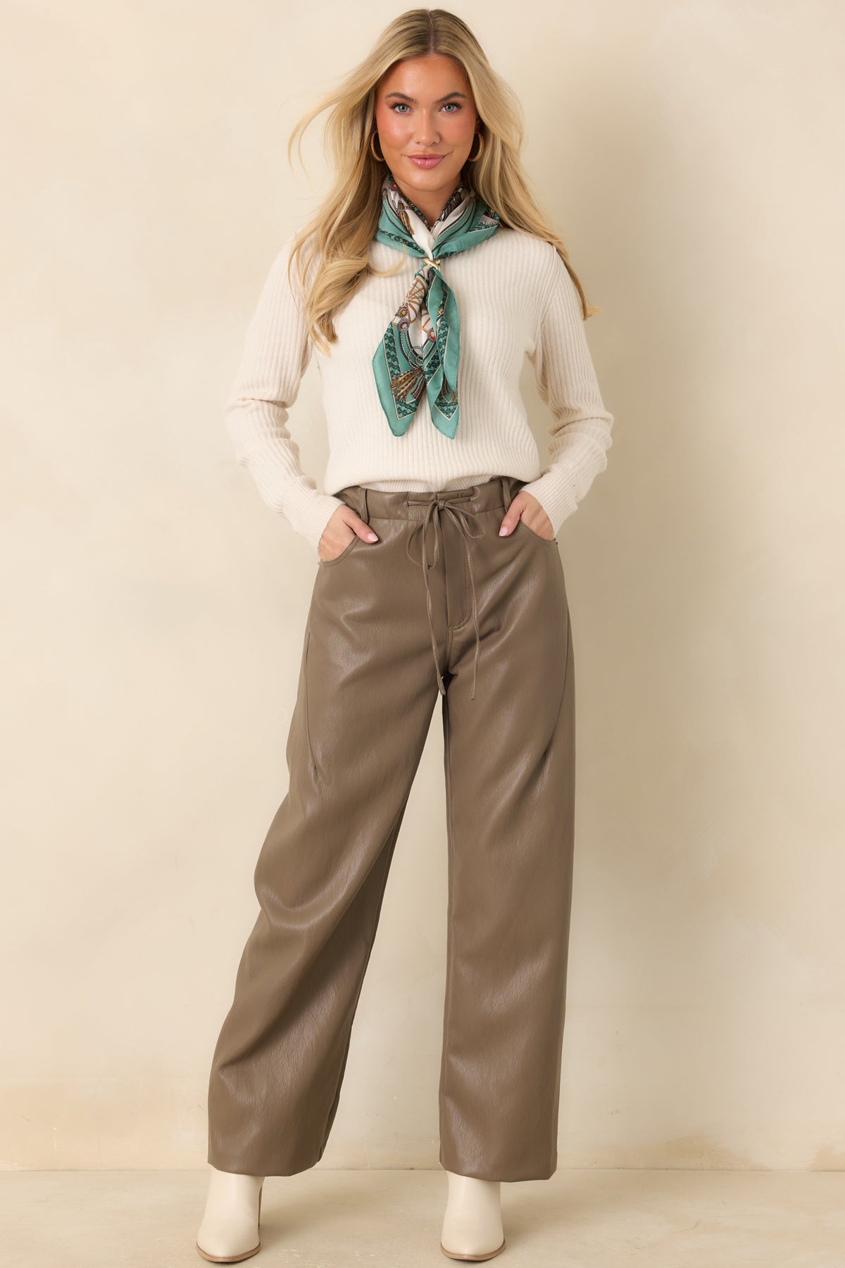Light brown faux leather pants with a high-rise elastic waistband, front drawstring, and wide legs.