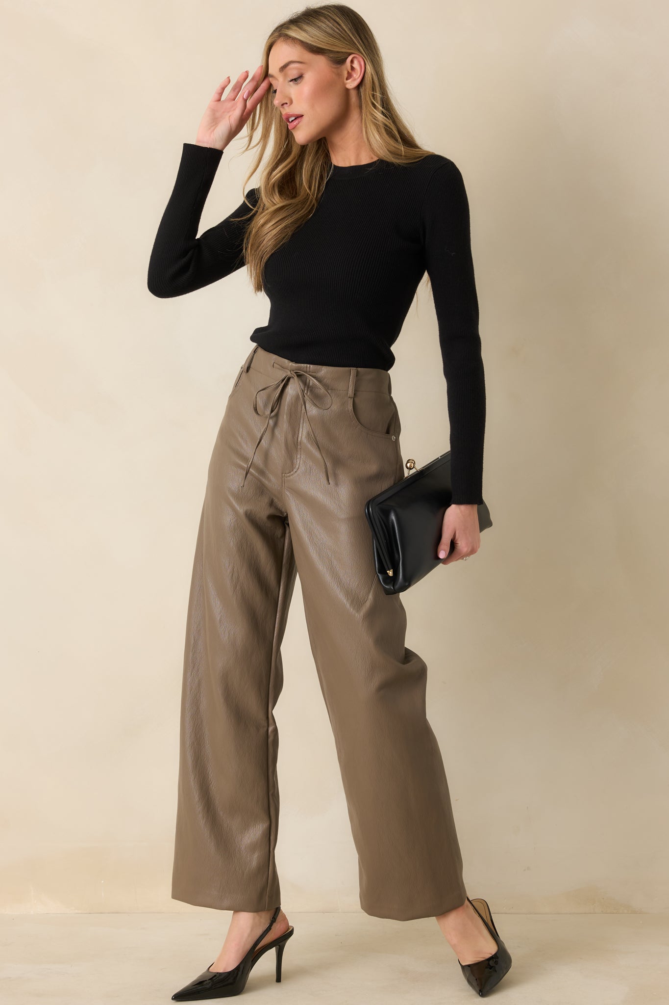Light brown faux leather pants showcasing an elastic waistband with an adjustable drawstring tie.