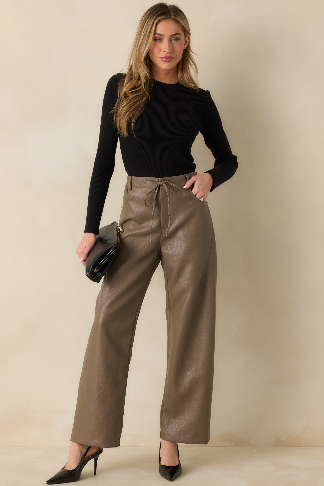 Light brown faux leather pants featuring a high-rise waist and relaxed wide-leg silhouette.