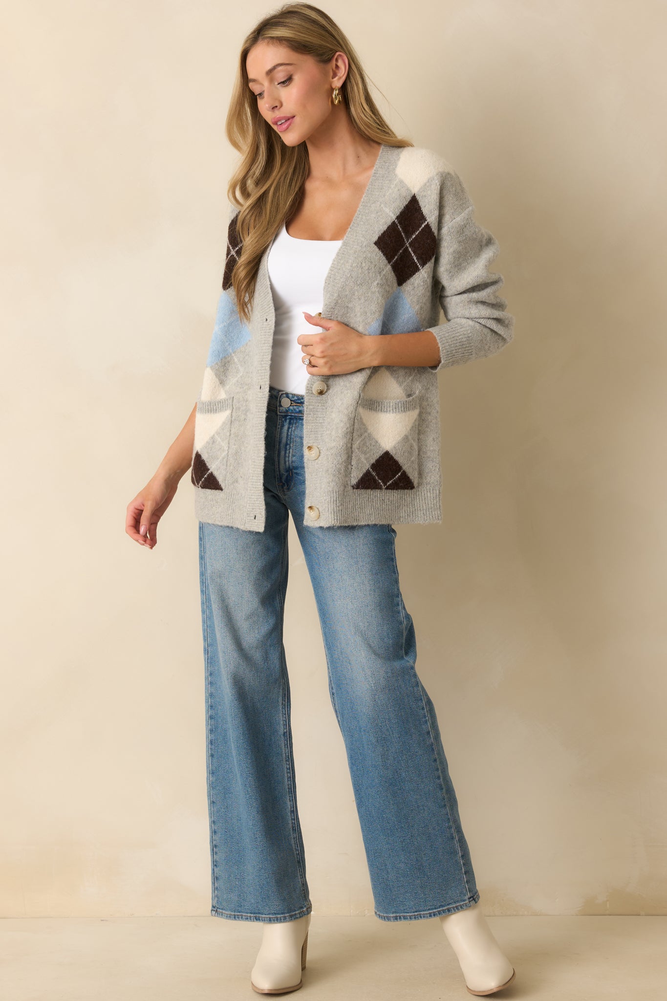 A full length front view showing the long sleeves, ribbed hems, and relaxed silhouette of the cardigan.
