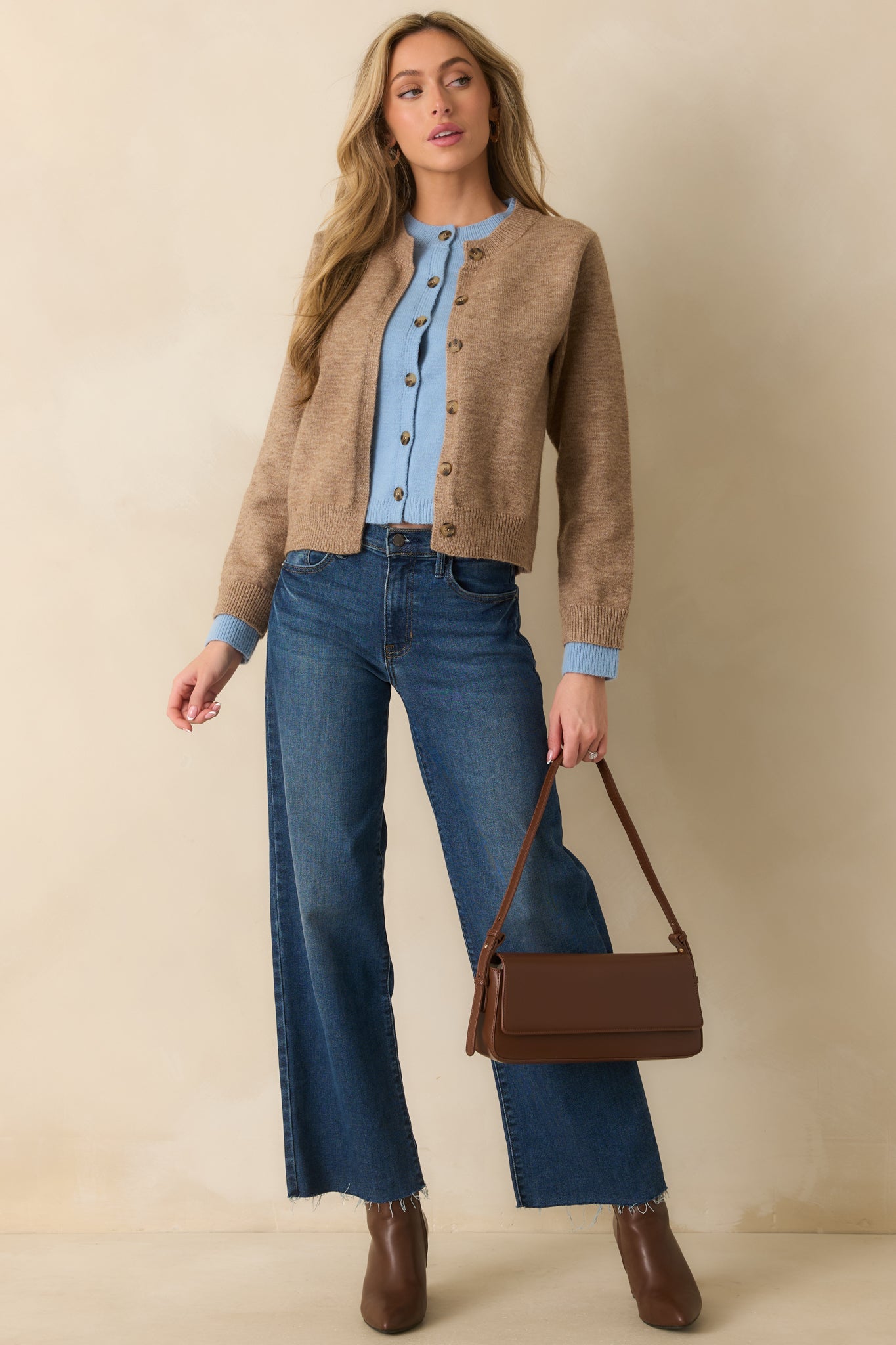 Light mocha knit cardigan with long sleeves, relaxed fit, and faux layered light blue detail along the front for a casual, cozy look.