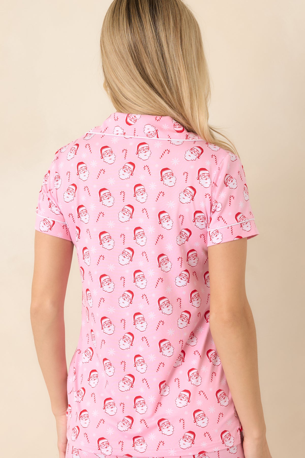 Rear of the light pink pajama top showcases the allover Santa and candy cane print with short sleeves.