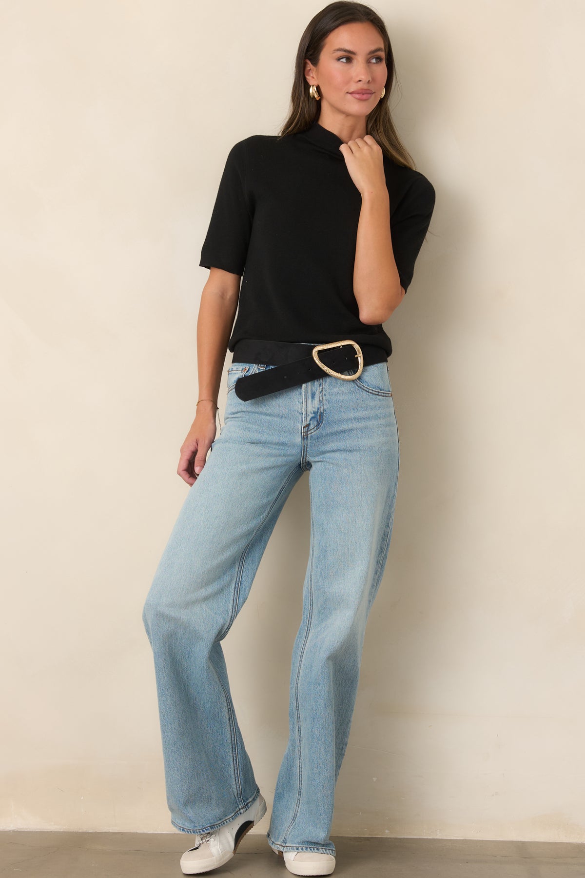 Light wash cotton jeans featuring a structured mid-rise waist, classic five-pocket styling, and a relaxed wide-leg silhouette.