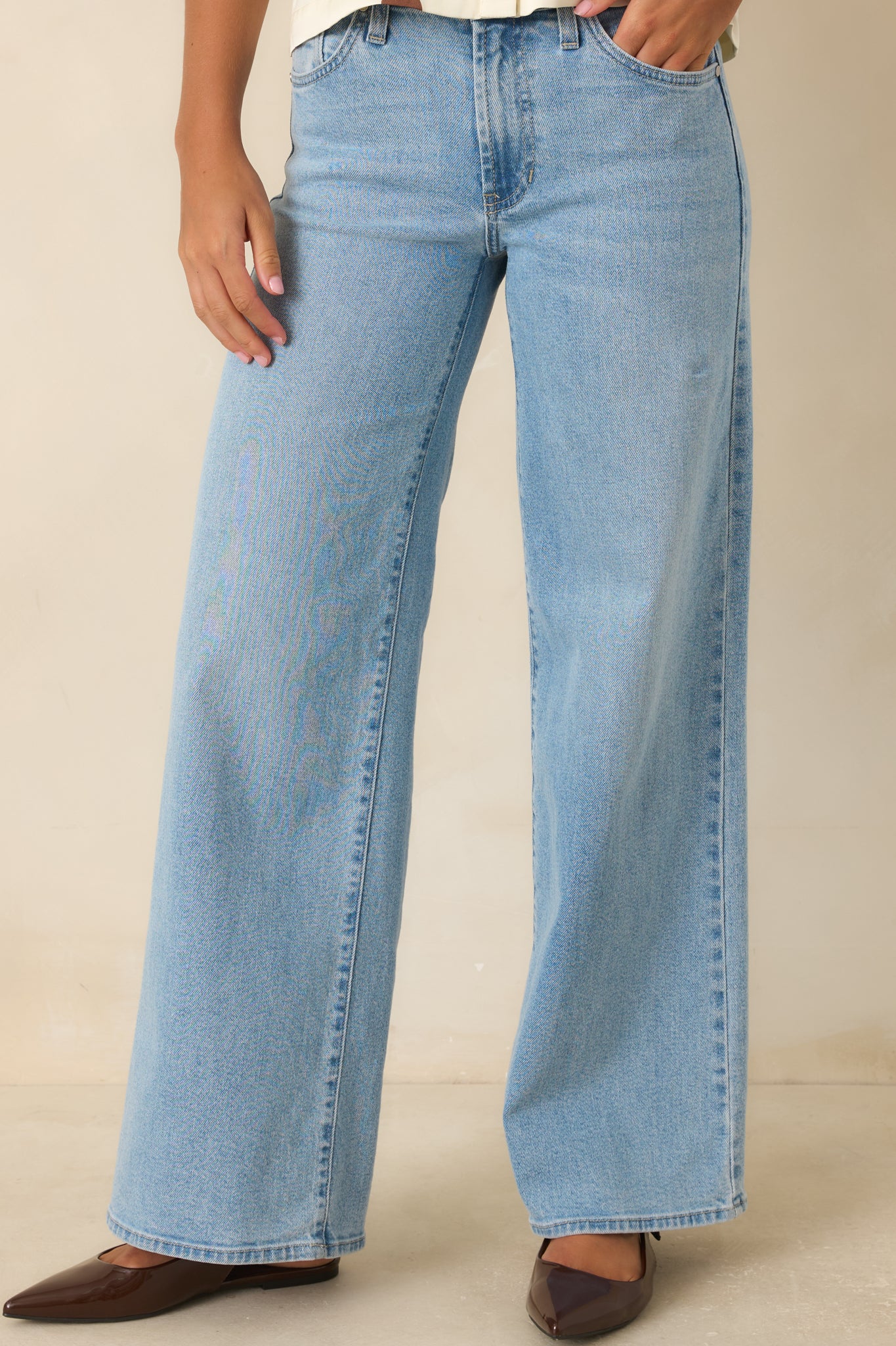 Light wash jeans featuring a high waist design, relaxed fit, straight leg cut, and classic denim styling.
