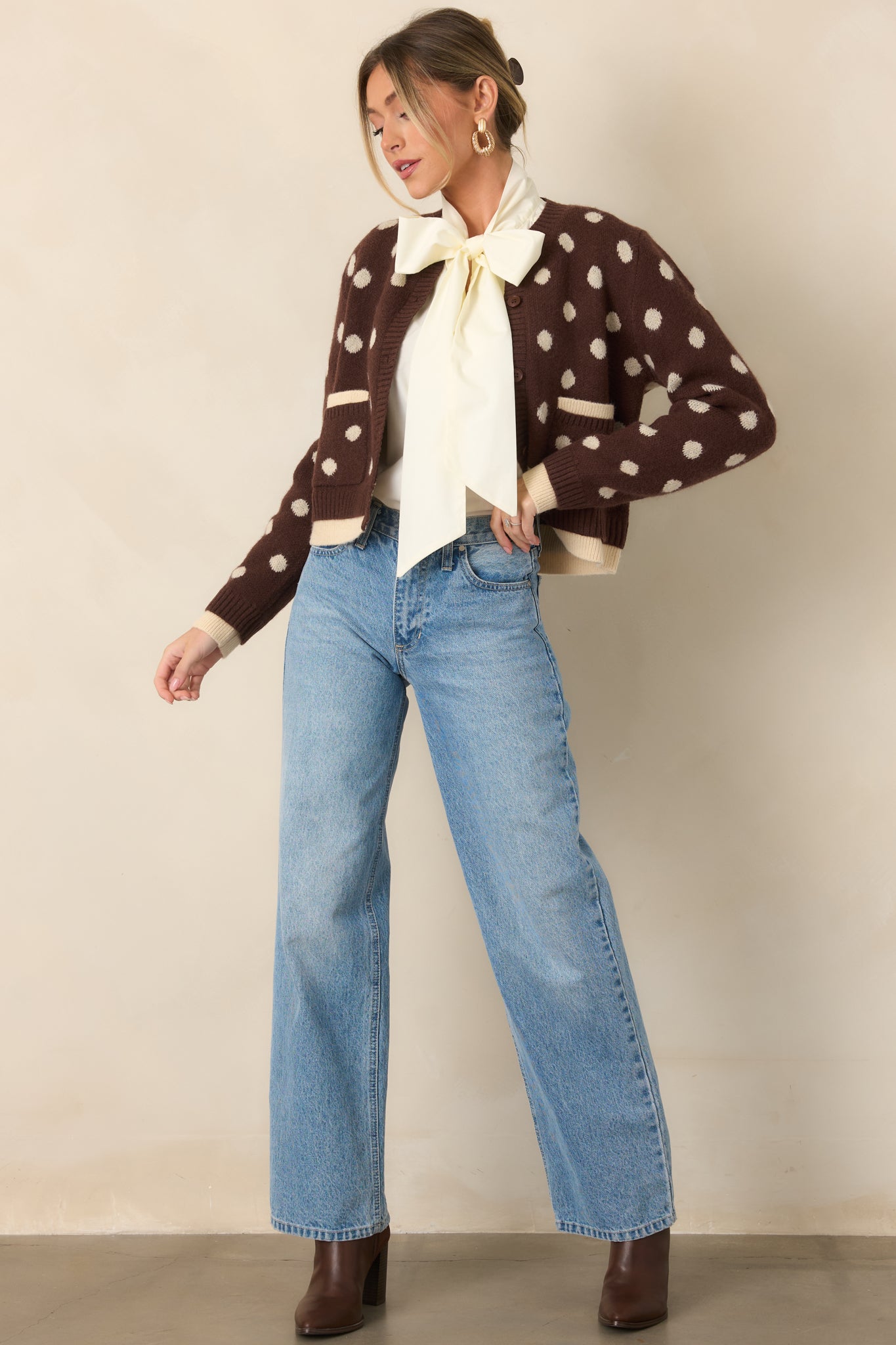 Light wash jeans featuring a high waist, relaxed fit, straight leg cut, and classic button and zip closure.