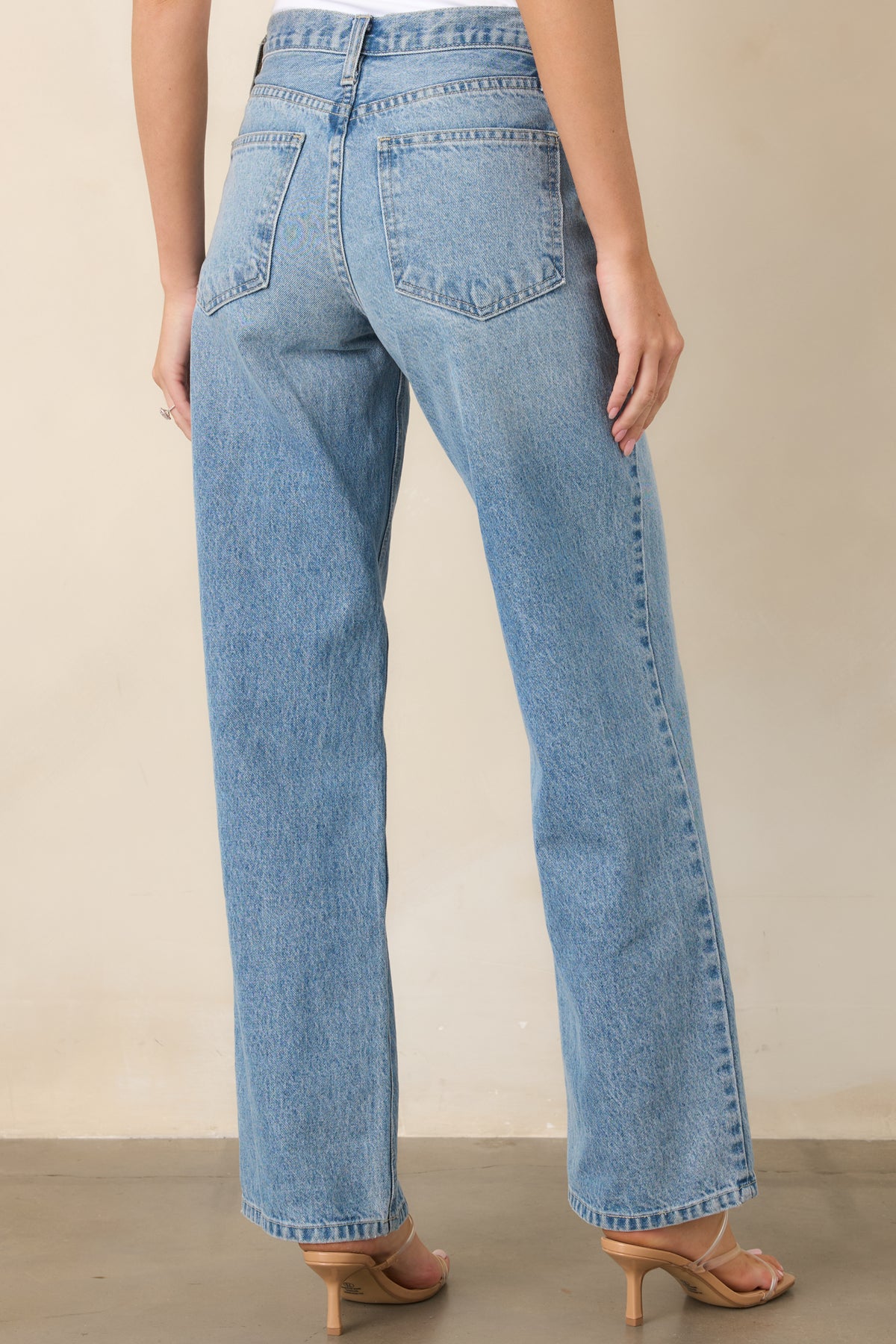 Rear view of the light wash jeans showcasing the relaxed straight-leg silhouette and high-rise waist.