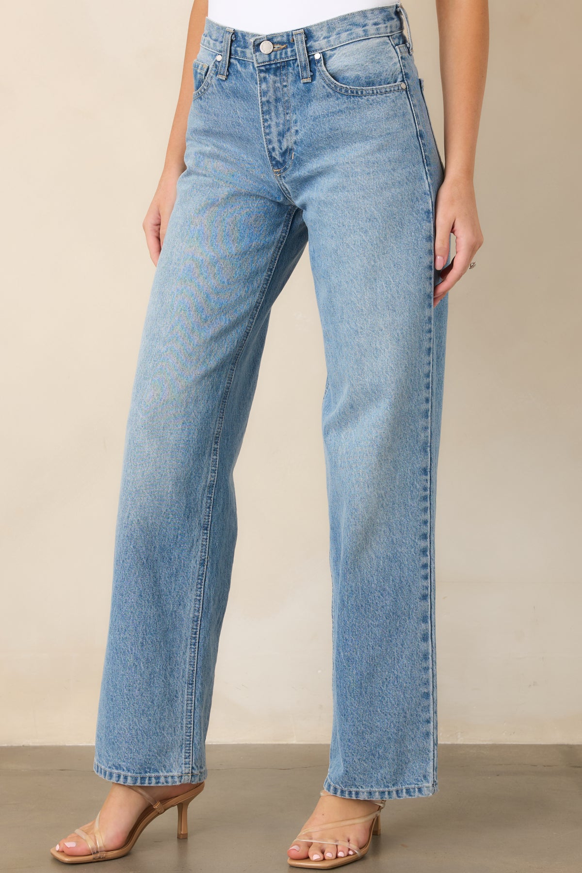 Light wash jeans showcasing the relaxed fit and straight leg construction through the clean denim silhouette.