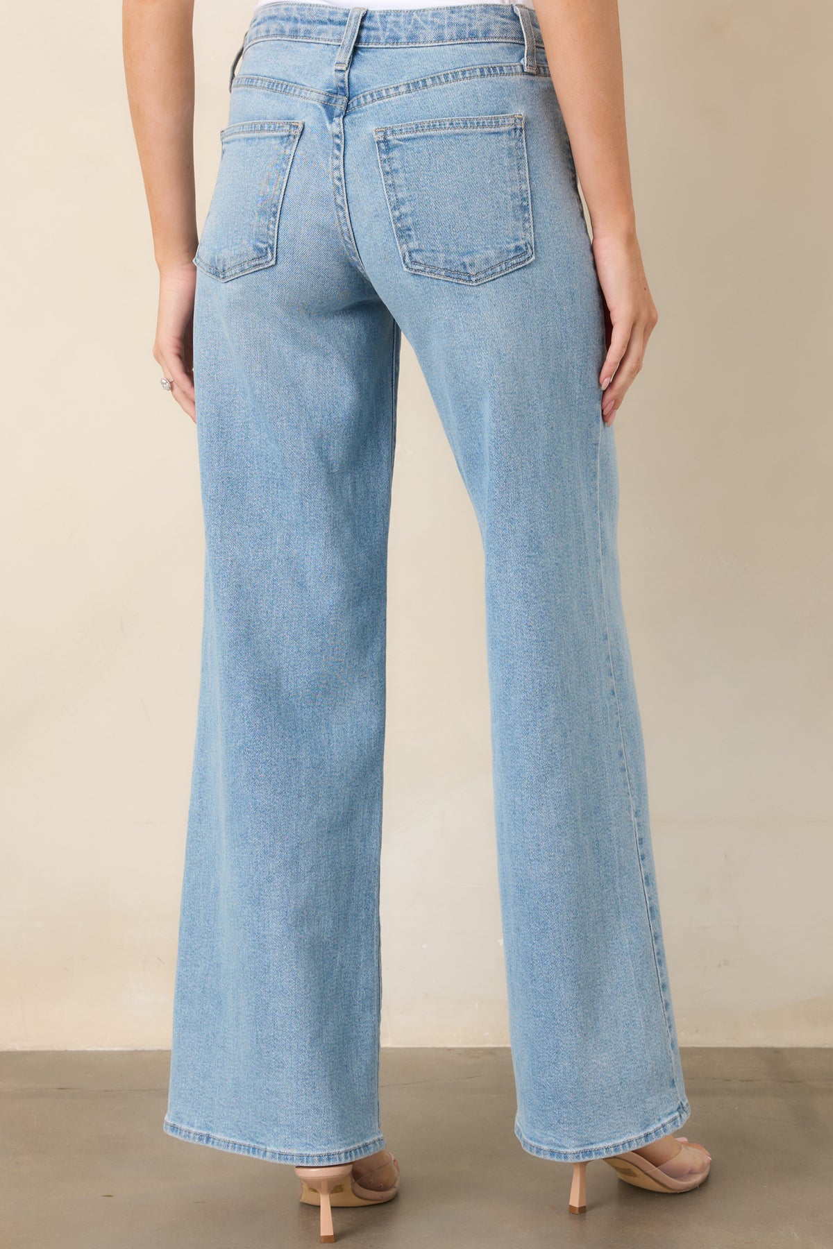 Rear view of the light-wash wide-leg jeans showcasing their relaxed silhouette and comfortable waist fit.