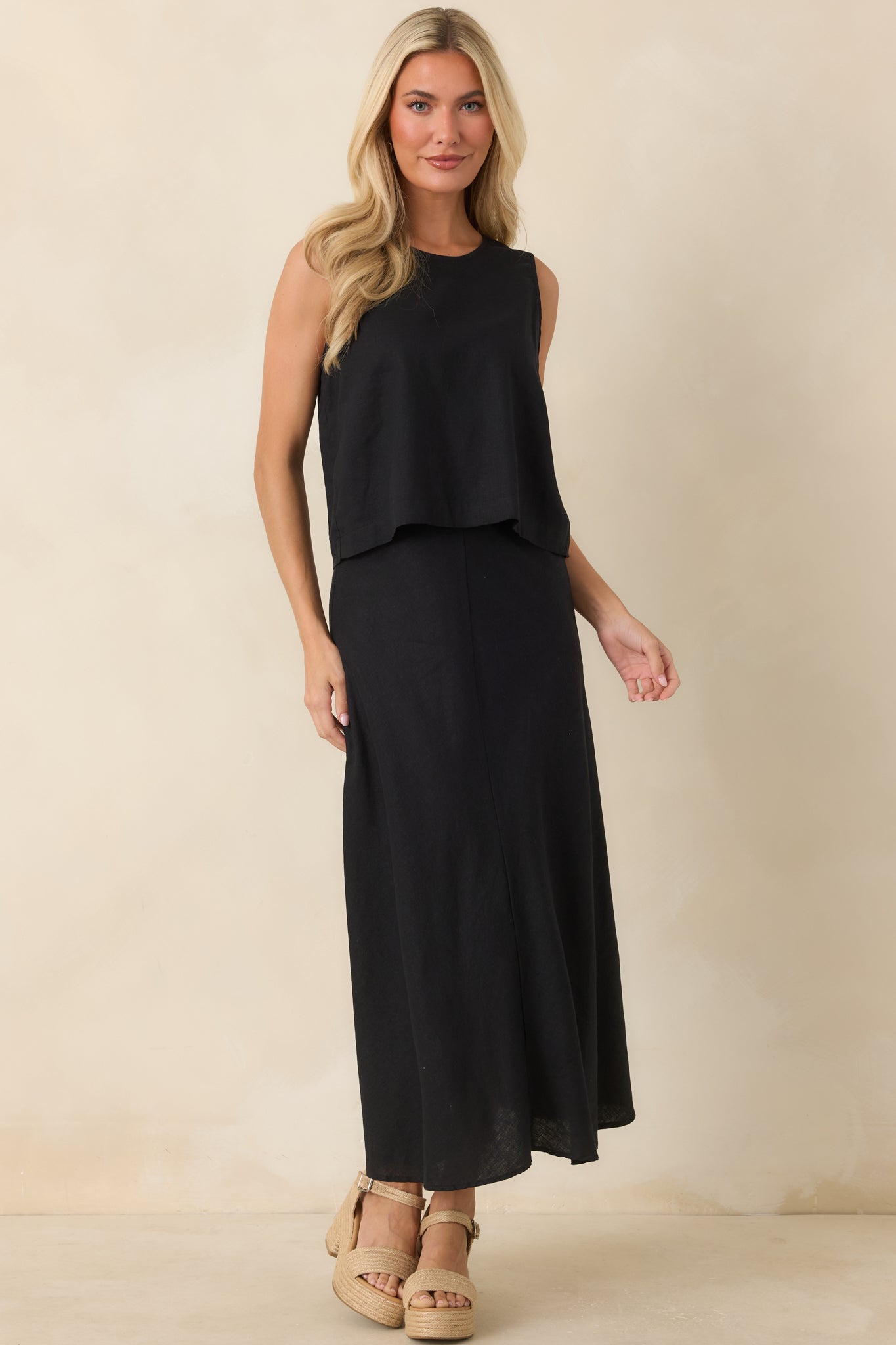 Lightweight black top designed with a modern boxy fit and breathable linen blend fabric.