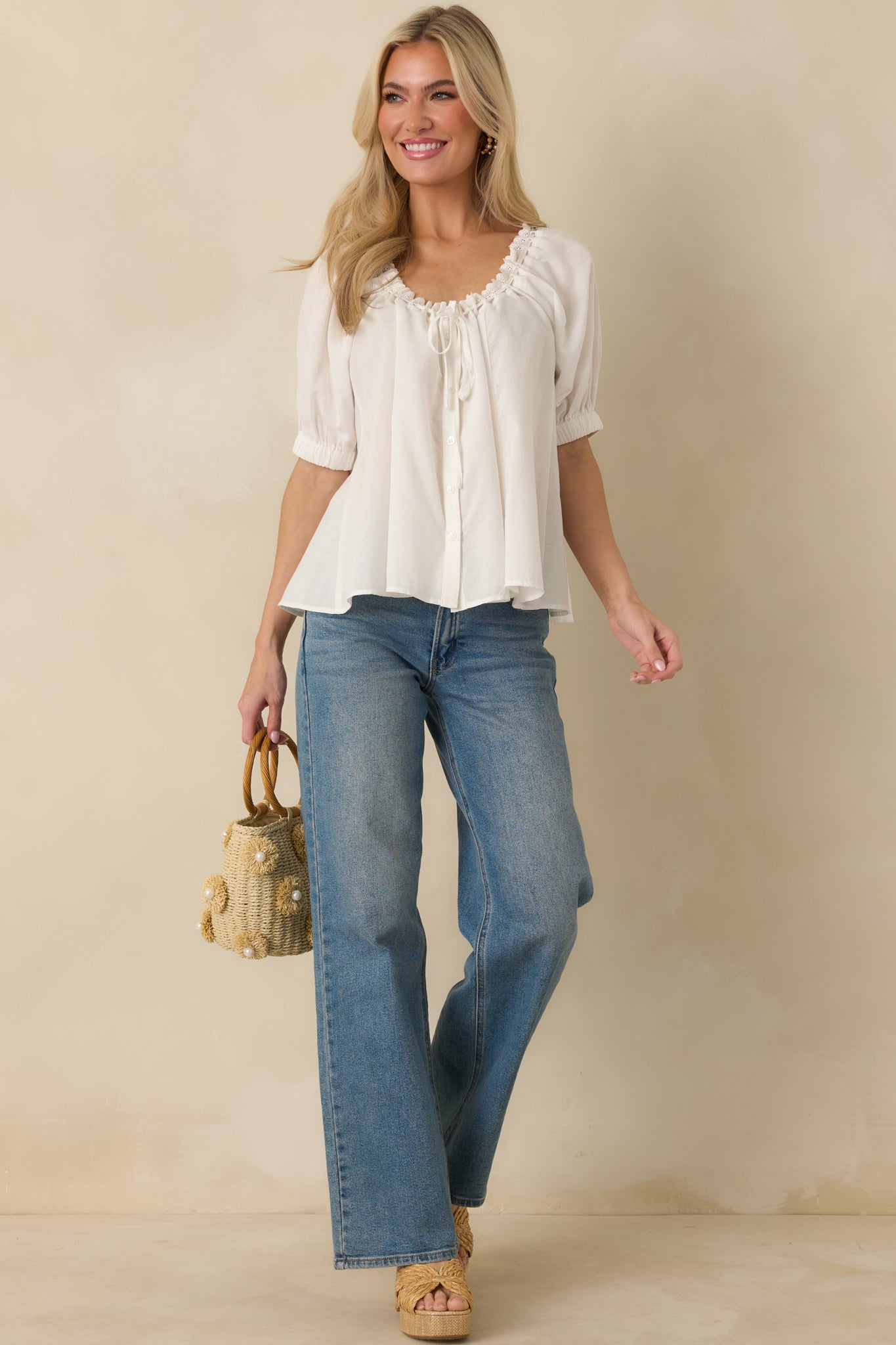 Lightweight blouse with lace-trimmed neckline, soft short sleeves, and functional button-front styling.