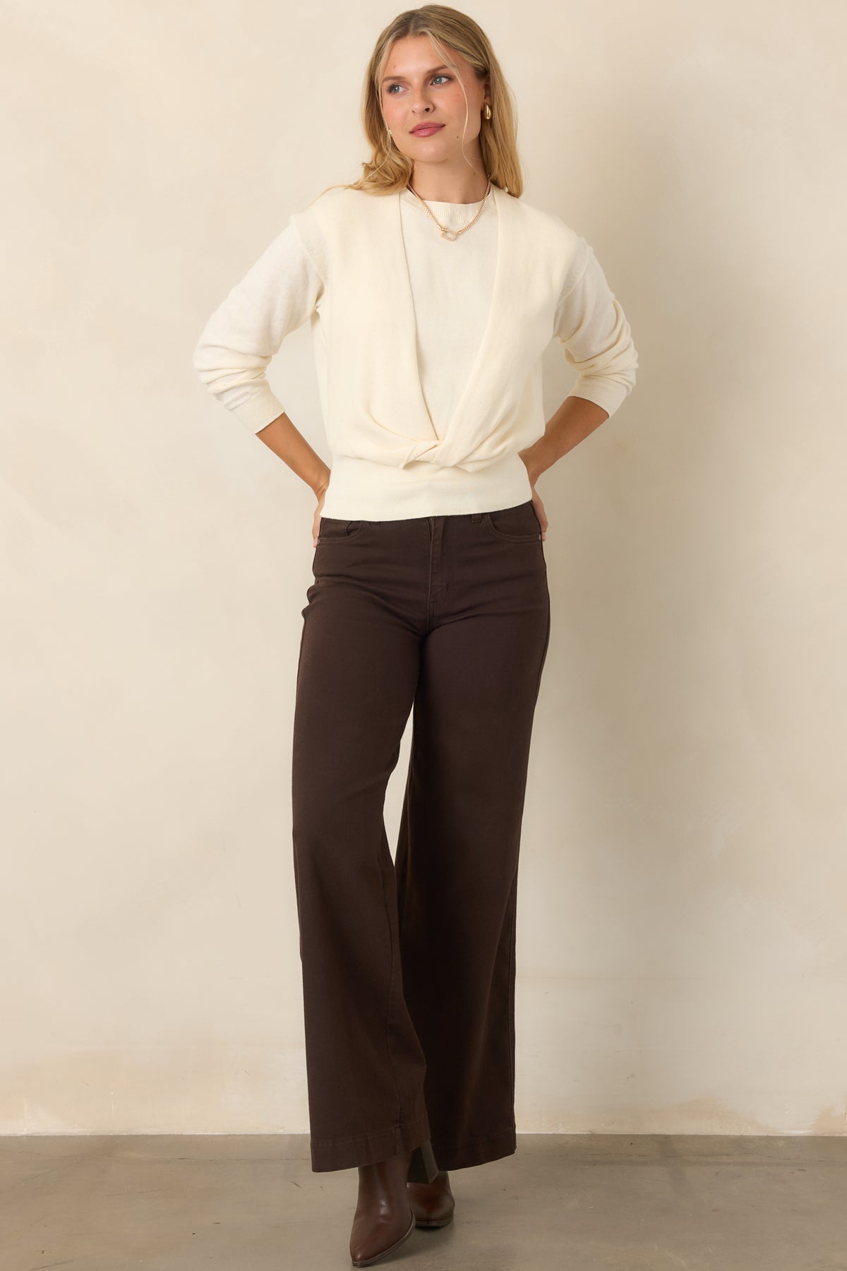 Lightweight cotton-cashmere blend sweater with a sleeveless crewneck base, long-sleeve overlay, distinctive front twist, and wide ribbed waistband.