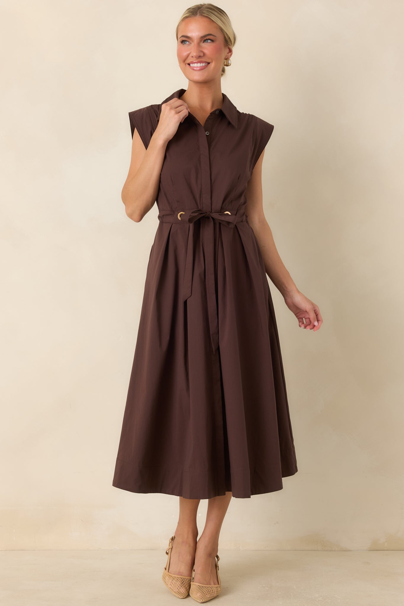 Lightweight cotton midi dress with a button-front design, fitted waist, and flowing skirt.