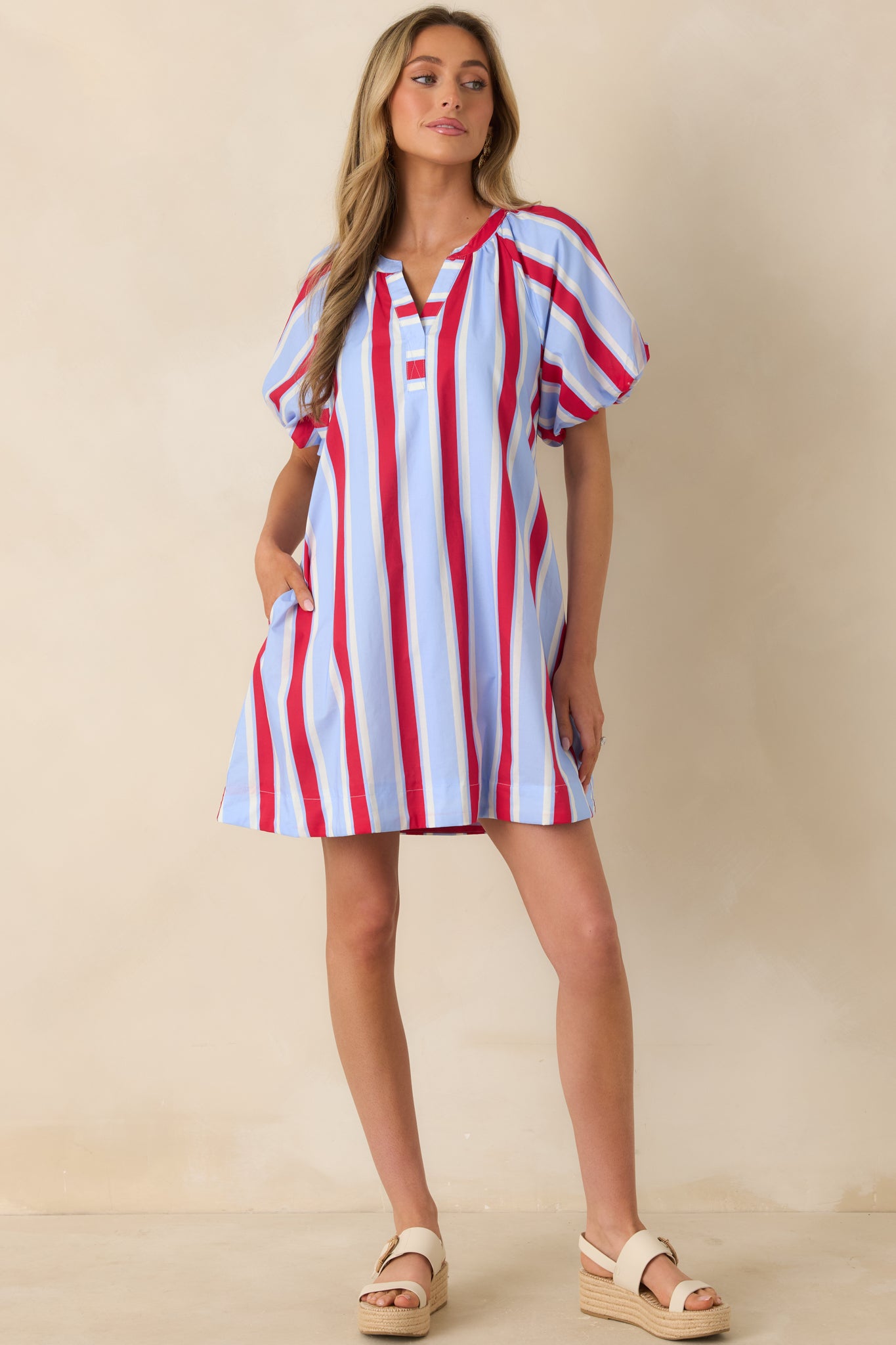 Lightweight cotton mini dress in playful red and soft blue stripes, featuring elasticized puff sleeves and easy fit
