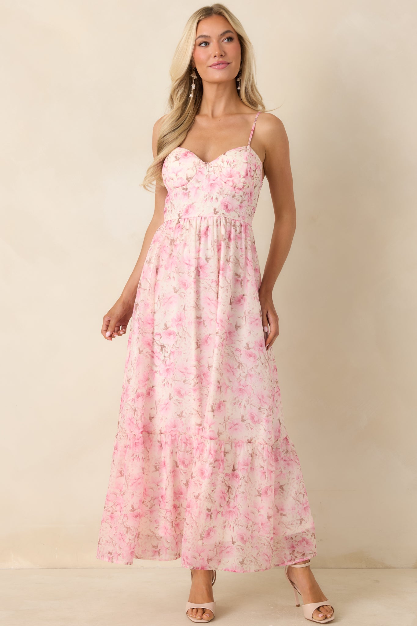Lightweight floral midi dress featuring a flowy silhouette and soft pink tones.