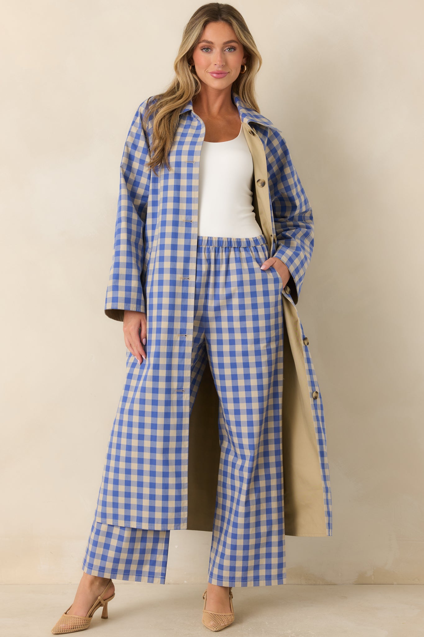 Lightweight reversible coat showcasing the gingham exterior with a relaxed silhouette, contrasting collar, and button-front closure.