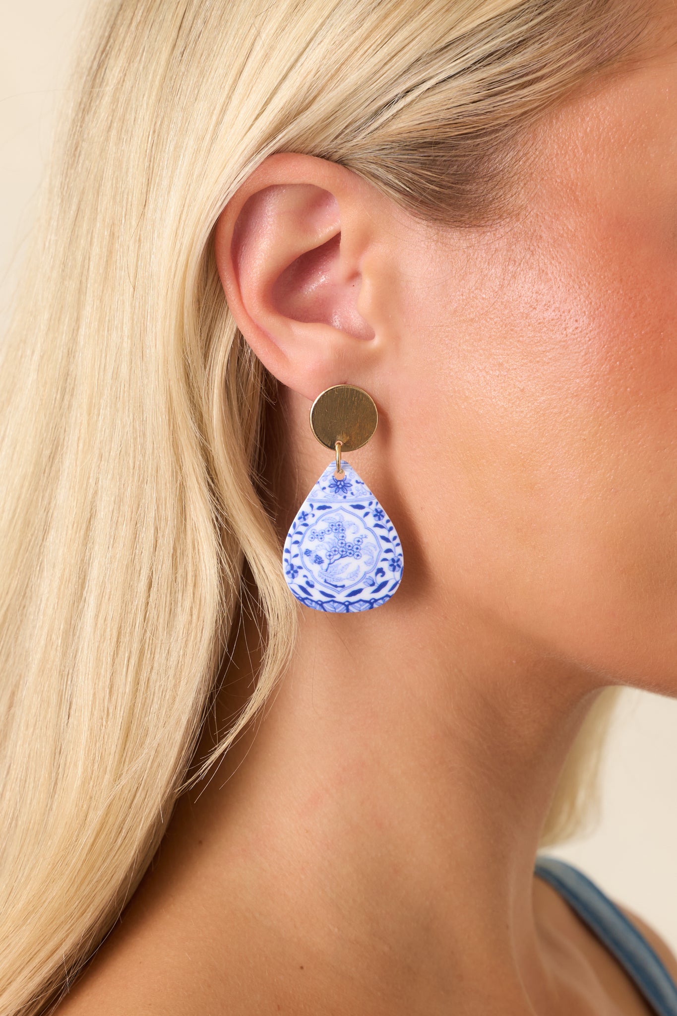 Lightweight gold-tone earrings showcasing intricate floral details, textured studs, and a vintage-inspired teardrop silhouette.