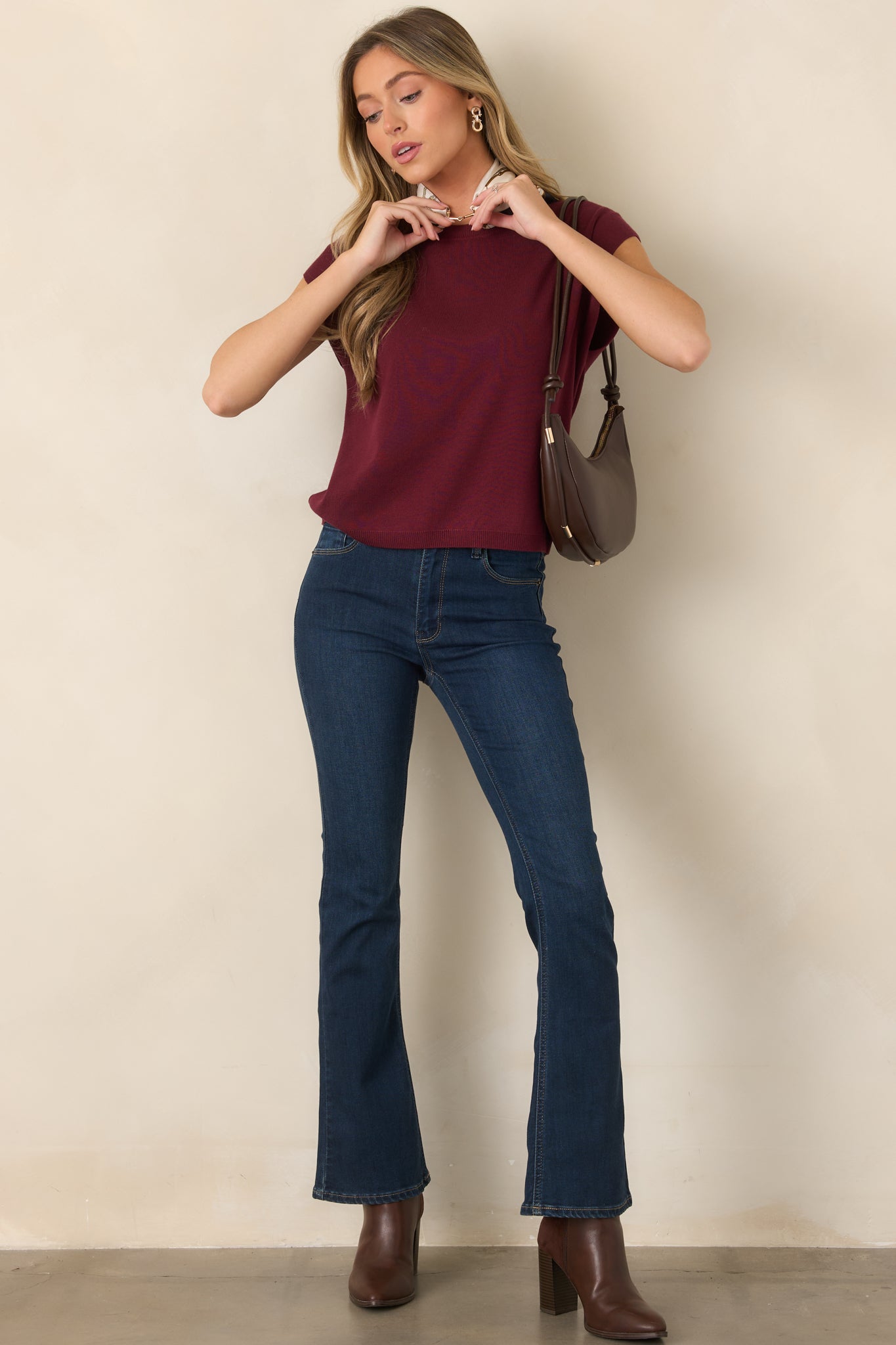 Lightweight knit top featuring a classic crew neckline, short relaxed sleeves, straight silhouette, and ribbed trim along the neckline and hem.