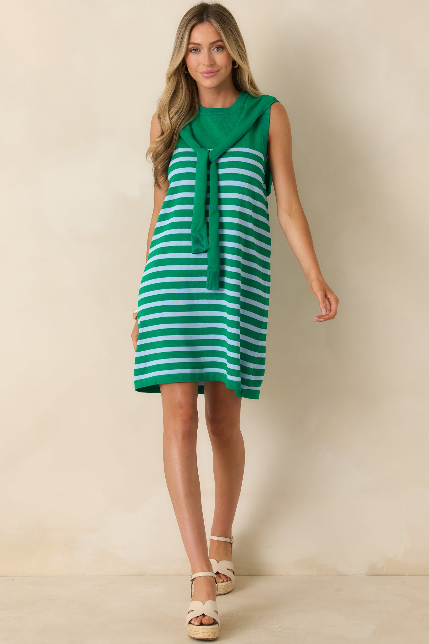 Lightweight knit mini dress featuring a classic crew neckline, sleeveless silhouette, and relaxed fit.