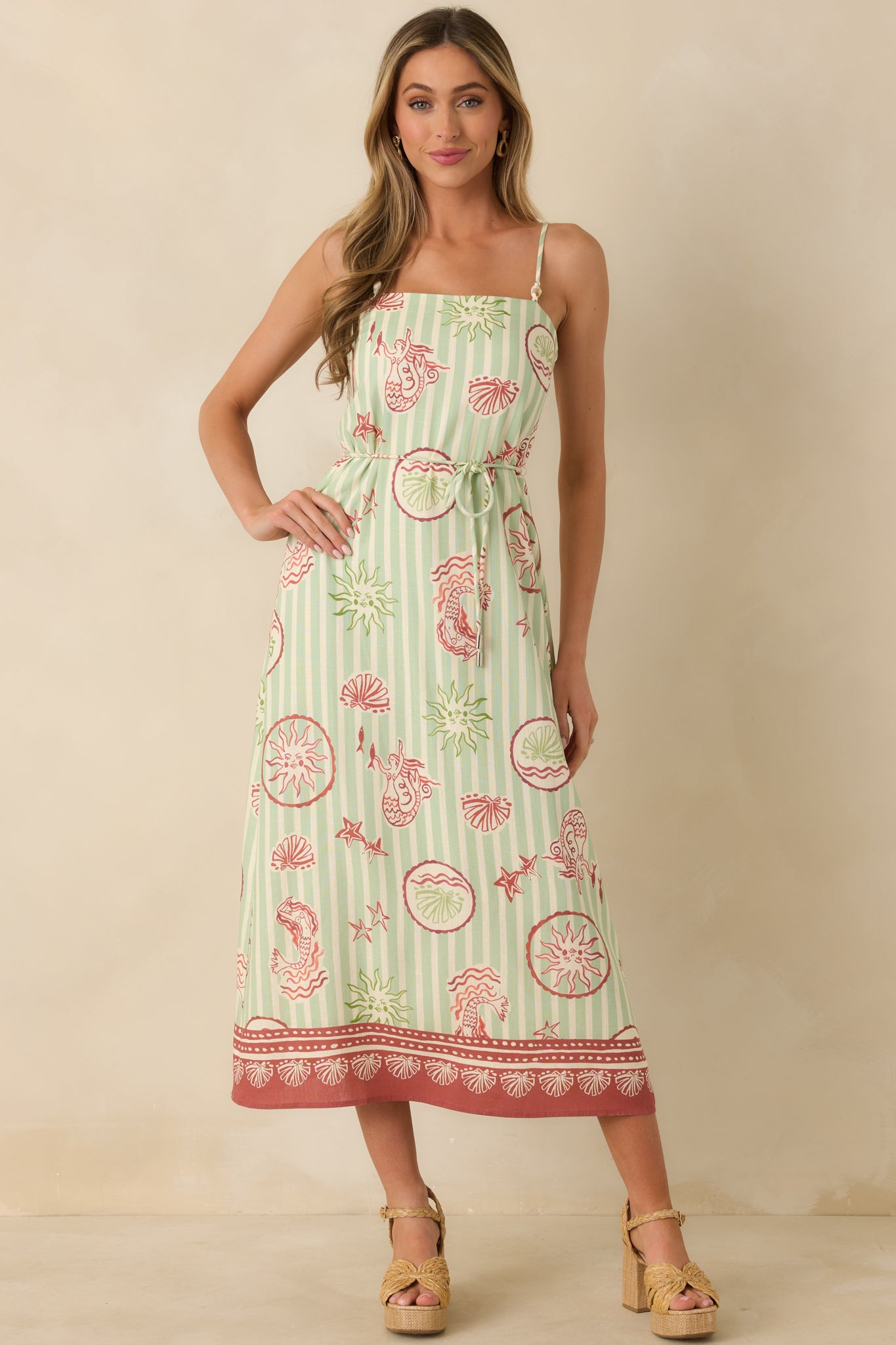 Front view of the lightweight linen-blend dress featuring a tie-waist detail and relaxed midi-length skirt.