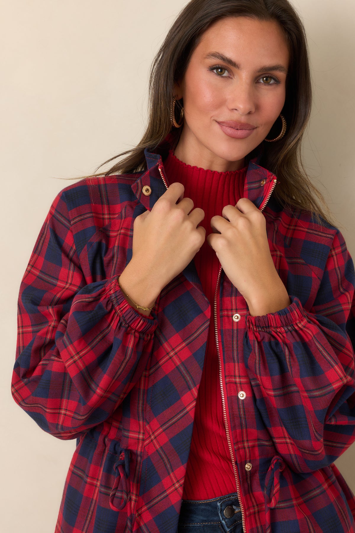 Lightweight red and navy plaid jacket featuring a structured collar, zip-front closure with snap accents, and oversized patch pockets.