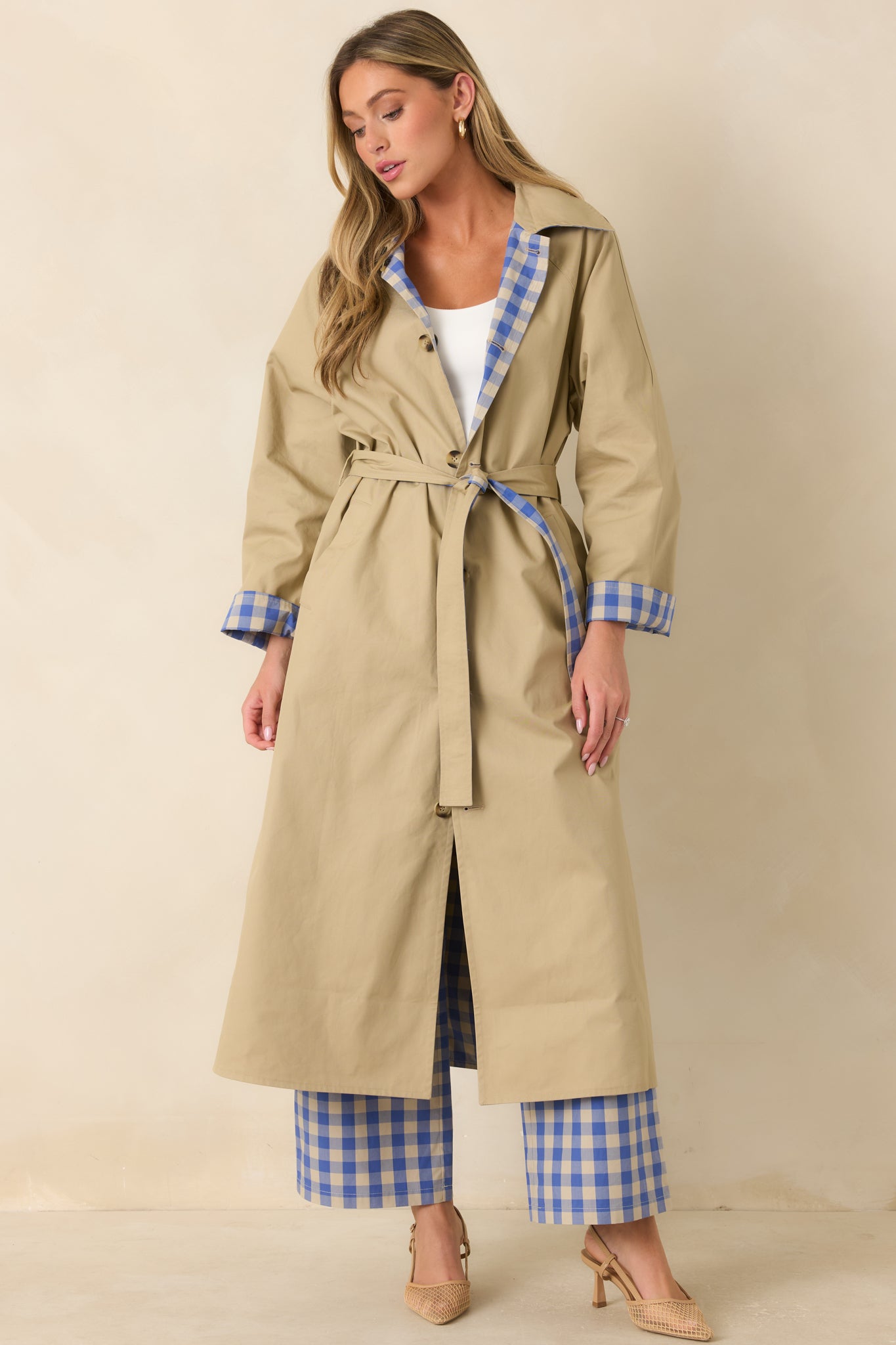 Lightweight reversible long coat featuring a beige exterior, contrasting gingham collar, full-length button front, and removable self-tie belt.